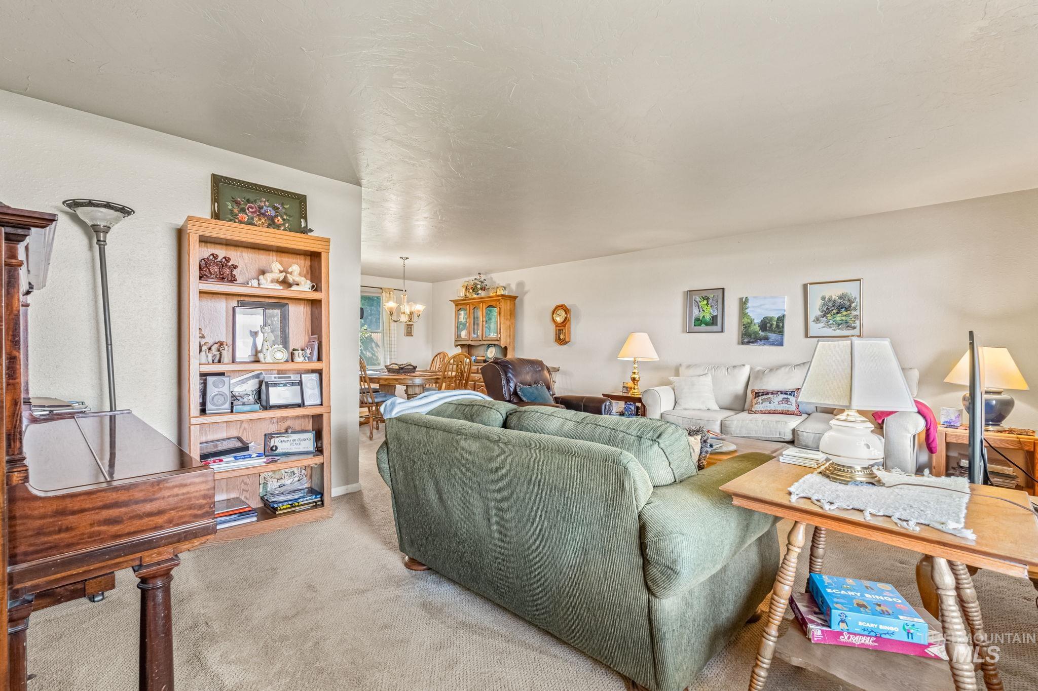 Living area with carpet and a chandelier