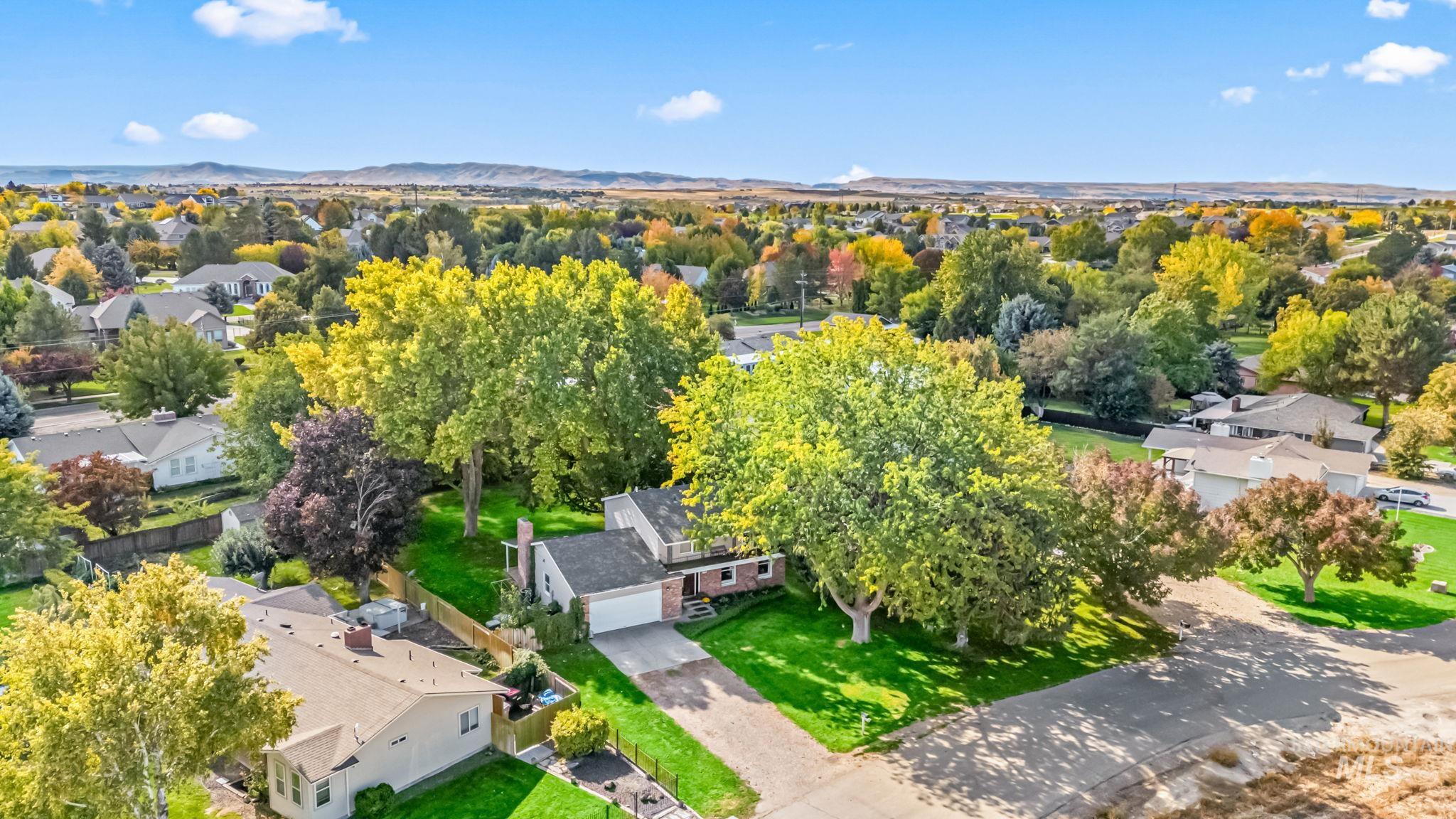 Aerial perspective of suburban area with a mountainous background
