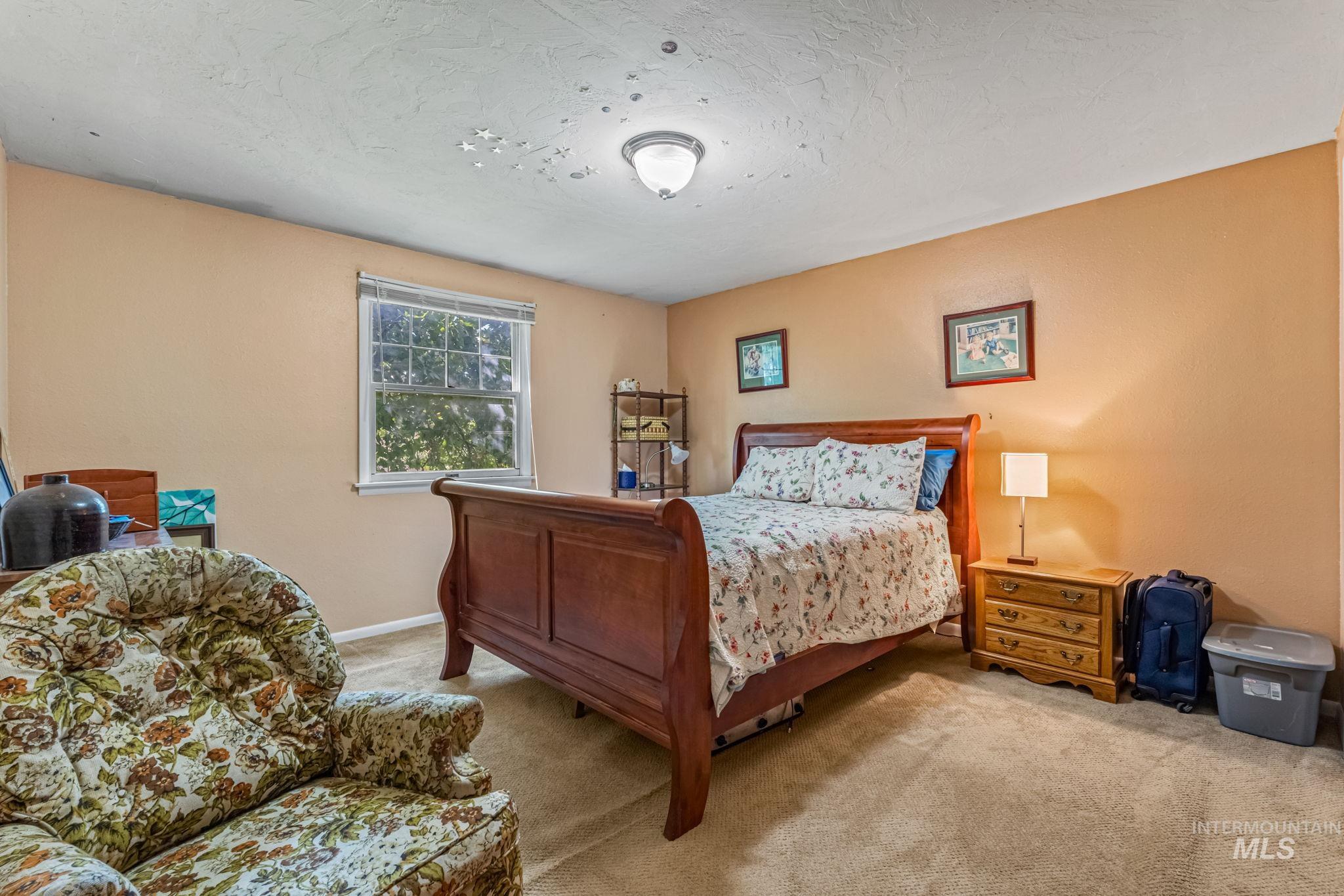 Carpeted bedroom with a textured ceiling