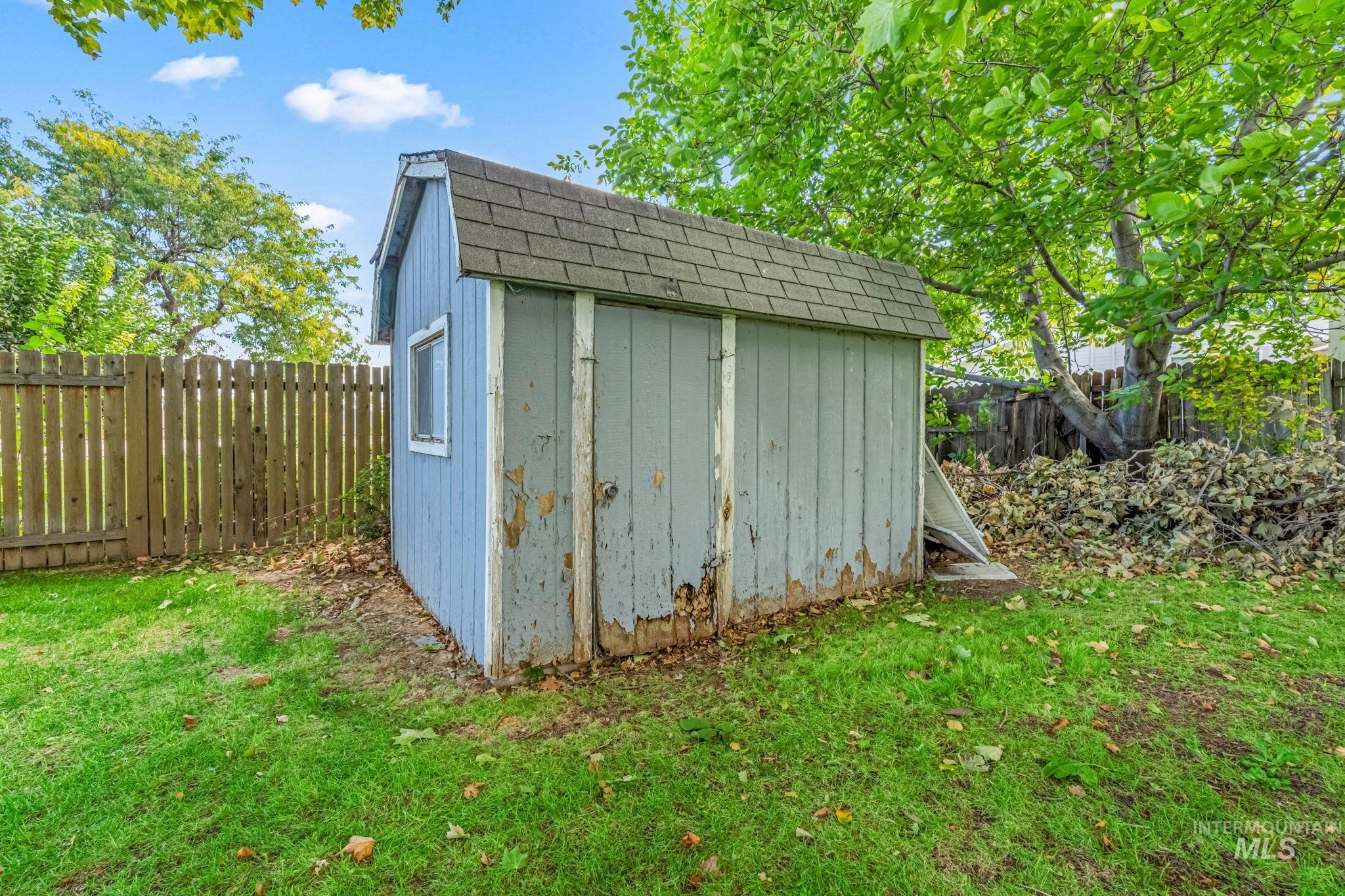 View of shed with a fenced backyard