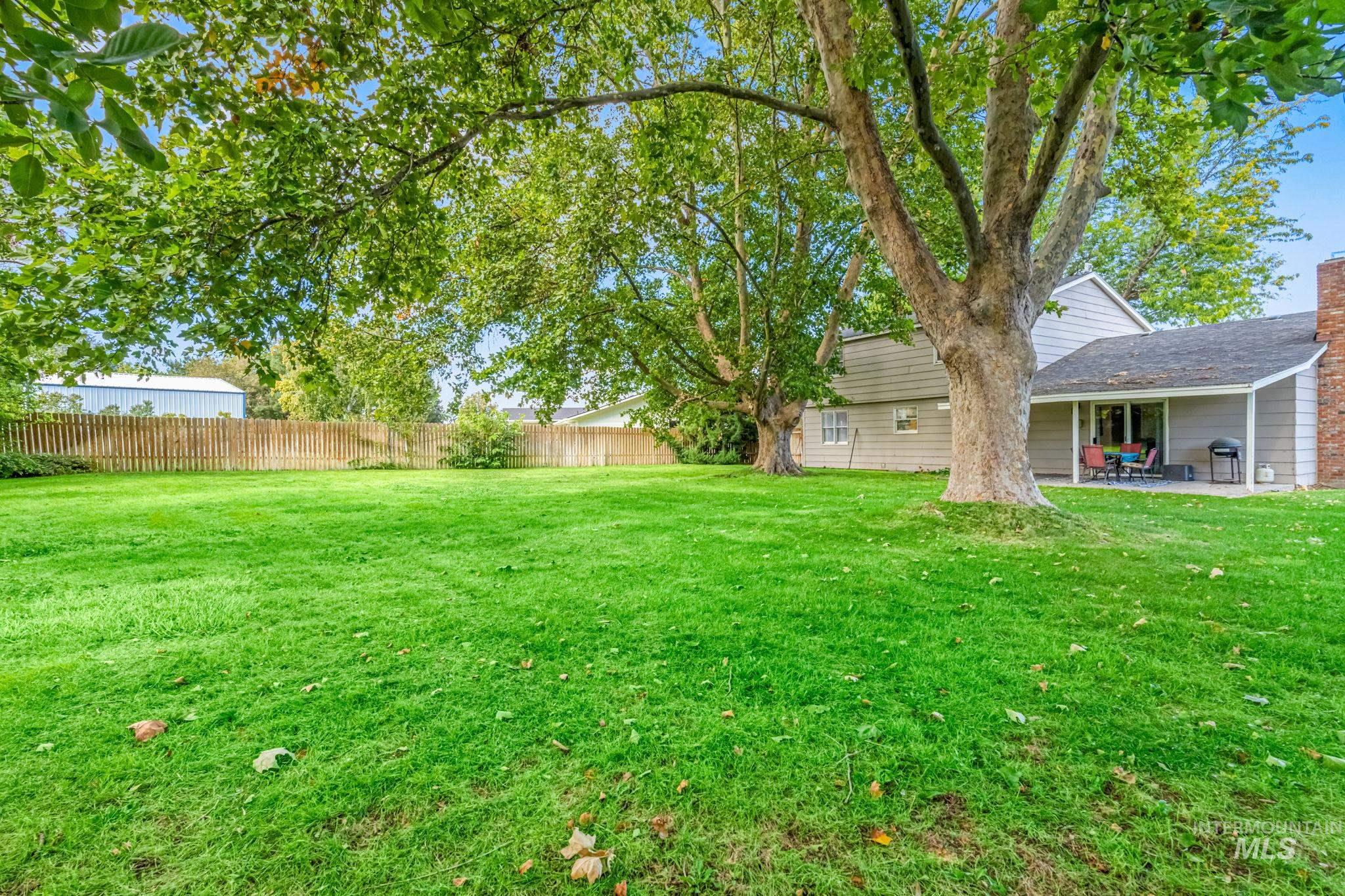 Fenced backyard featuring a patio