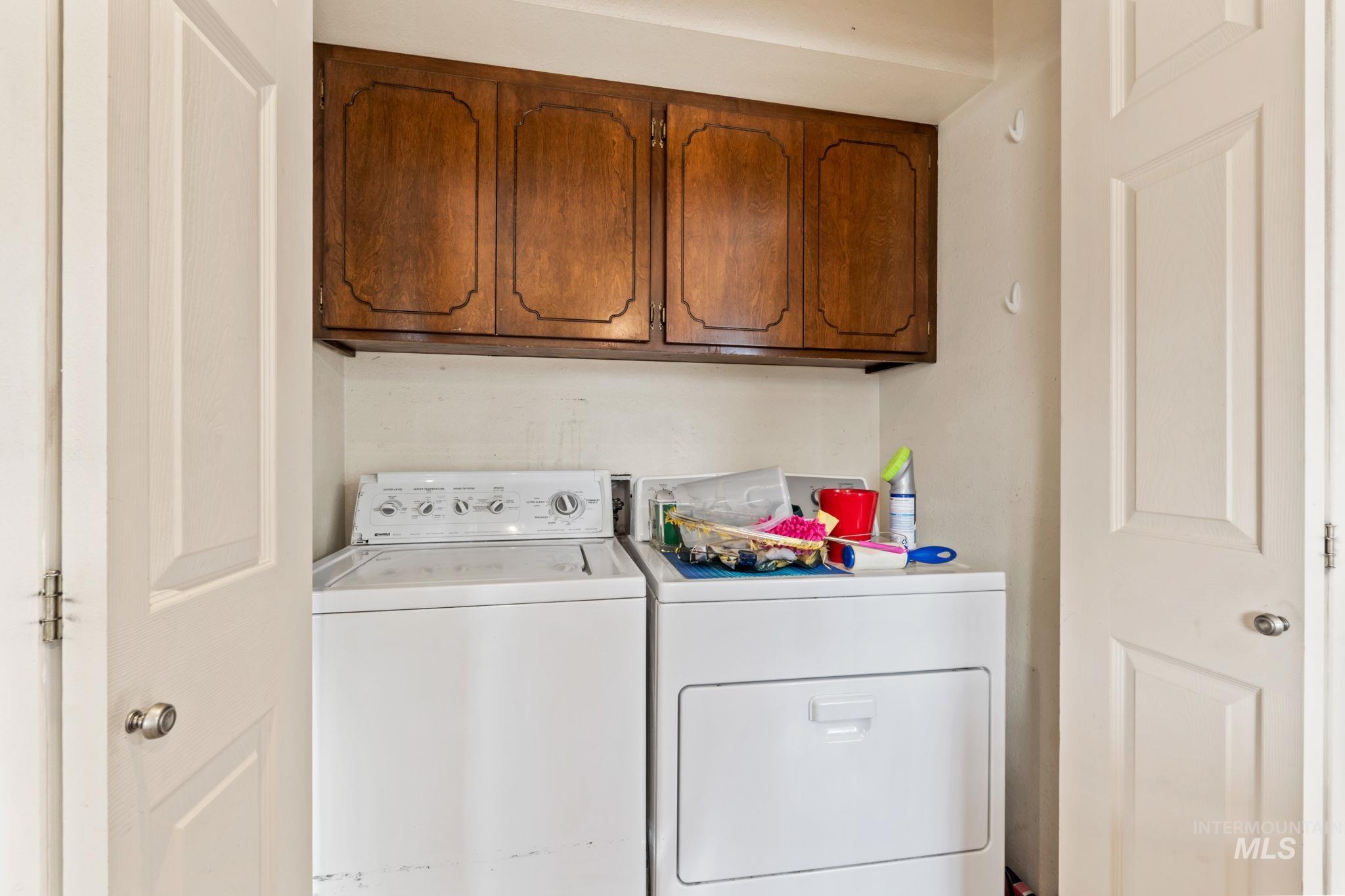 Laundry room featuring cabinet space and washing machine and clothes dryer