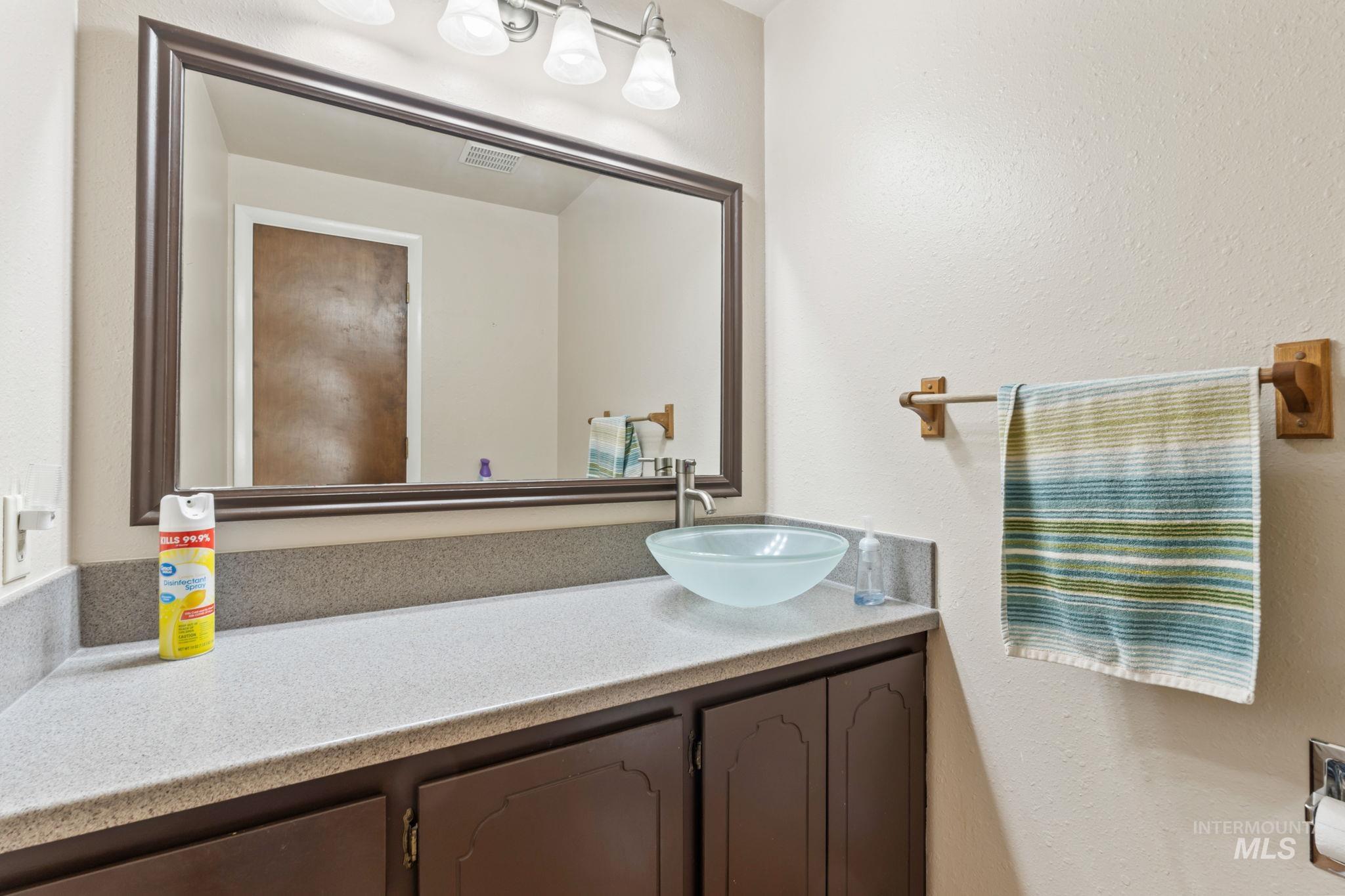 Bathroom featuring vanity and a textured wall