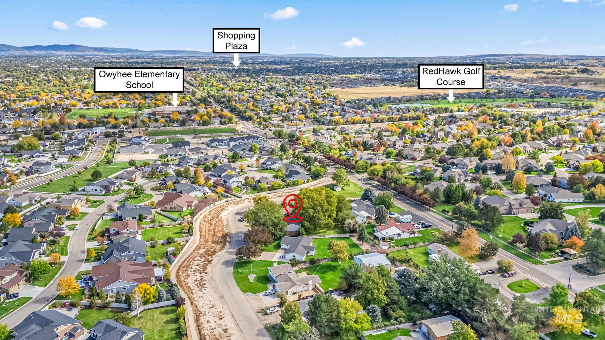 Aerial view of property and surrounding area with nearby suburban area
