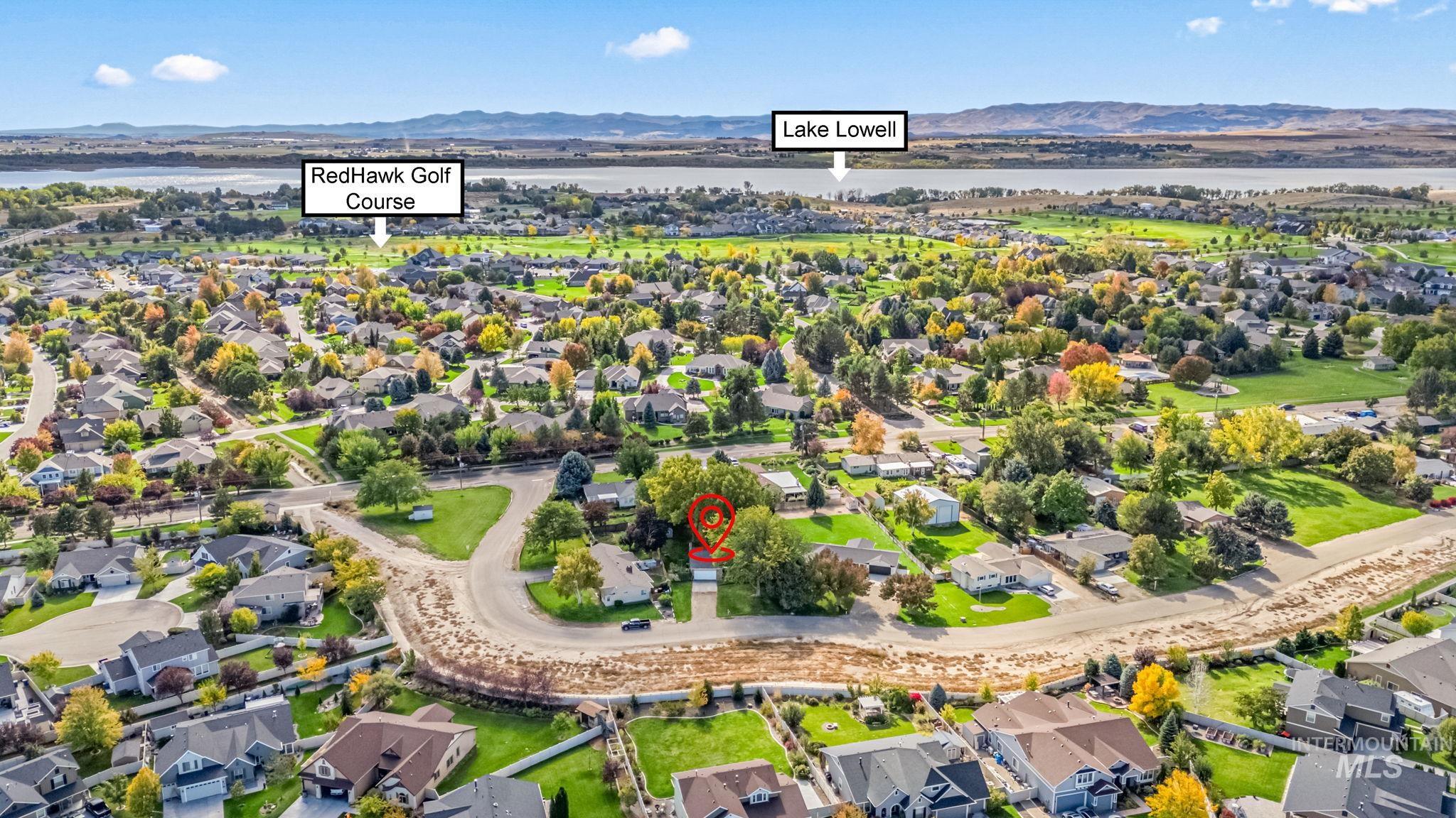 Aerial perspective of suburban area with a water and mountain view
