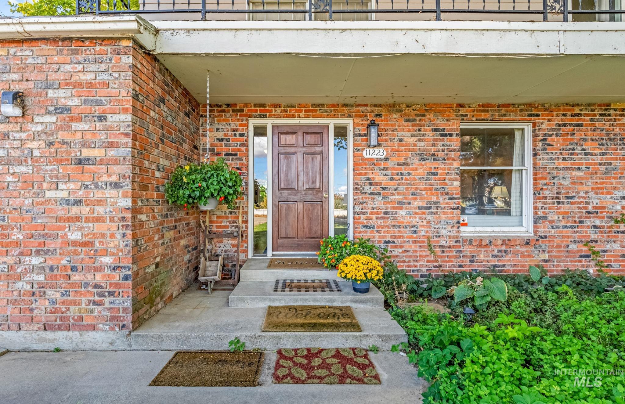 View of exterior entry with brick siding