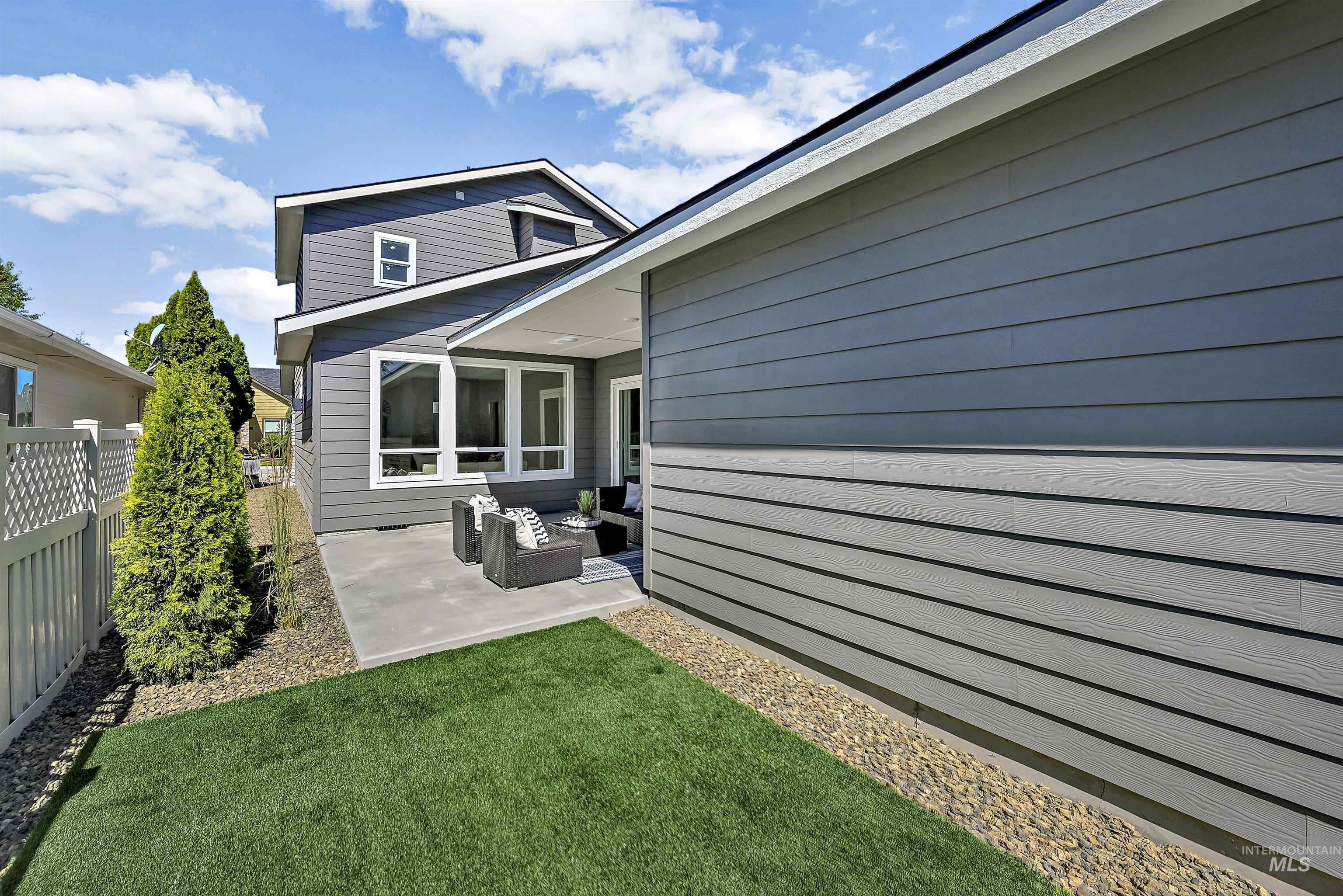 Rear view of house with a patio area, a fenced backyard, and an outdoor living space