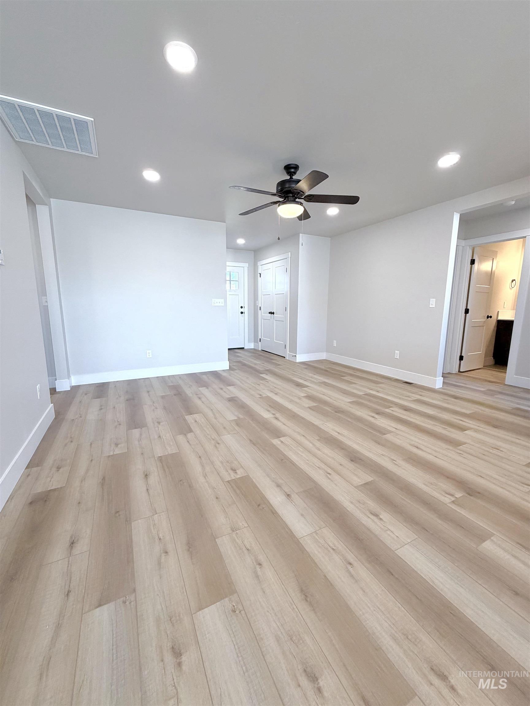 Unfurnished living room with light wood-style floors, recessed lighting, and ceiling fan