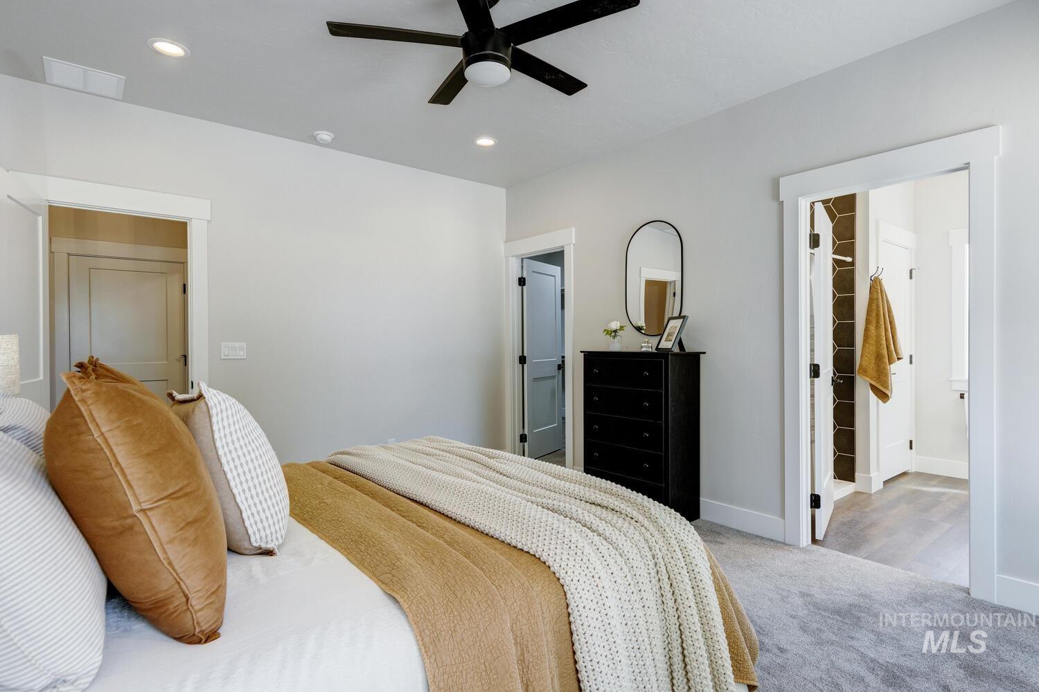 Bedroom with carpet, a spacious closet, recessed lighting, and a ceiling fan