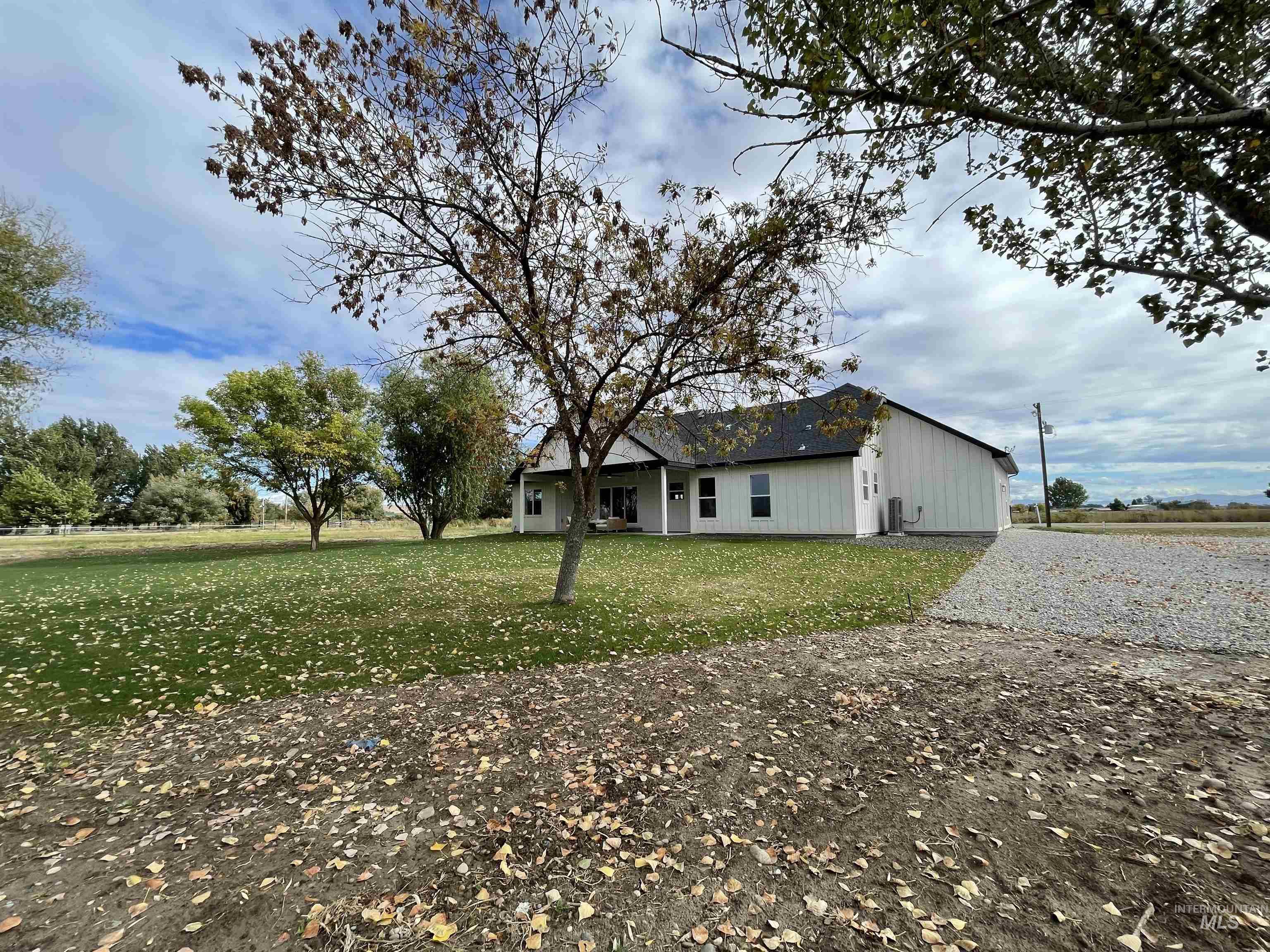 View of property exterior featuring a yard and a patio