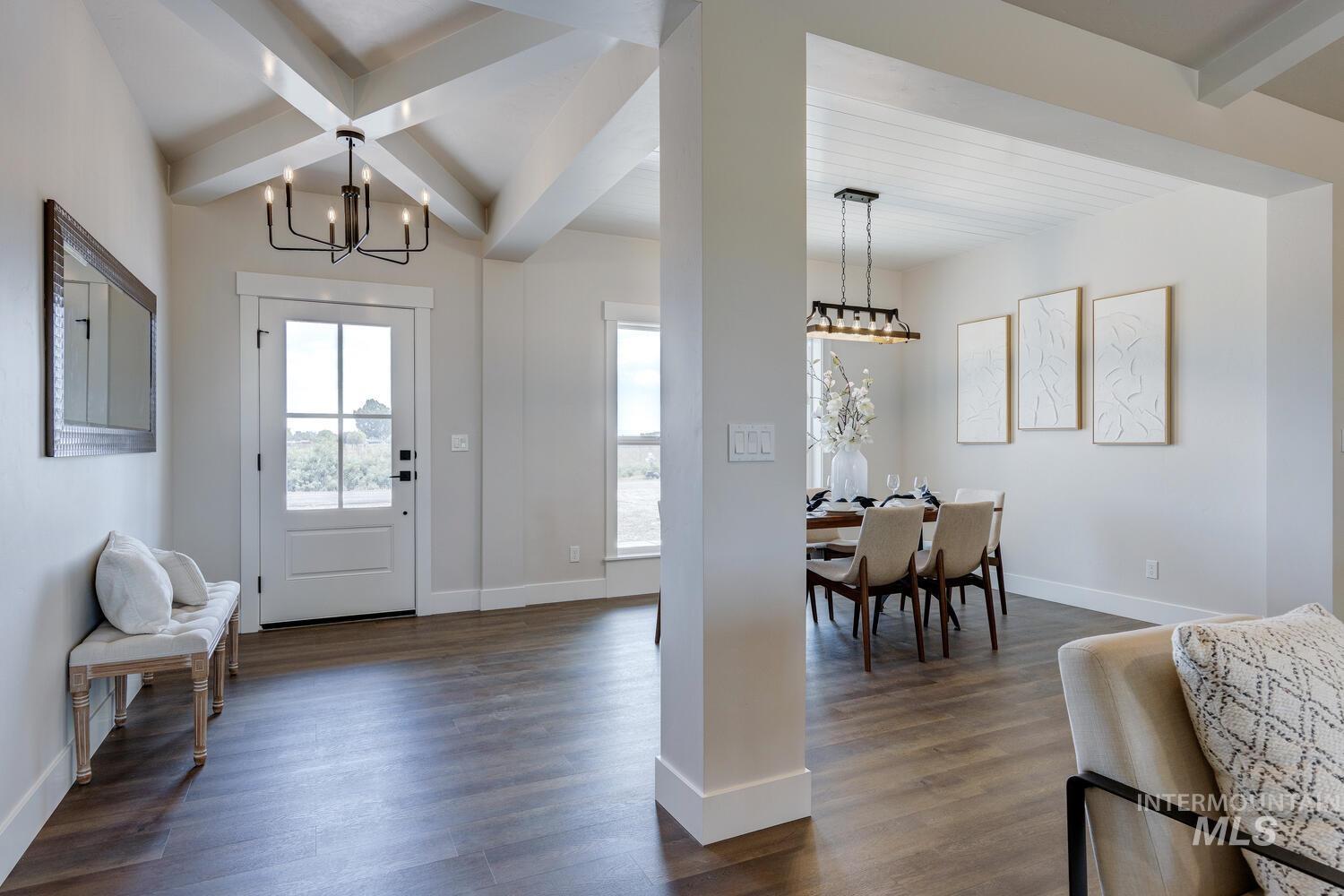 Entryway featuring beam ceiling, a chandelier, and dark wood-style flooring