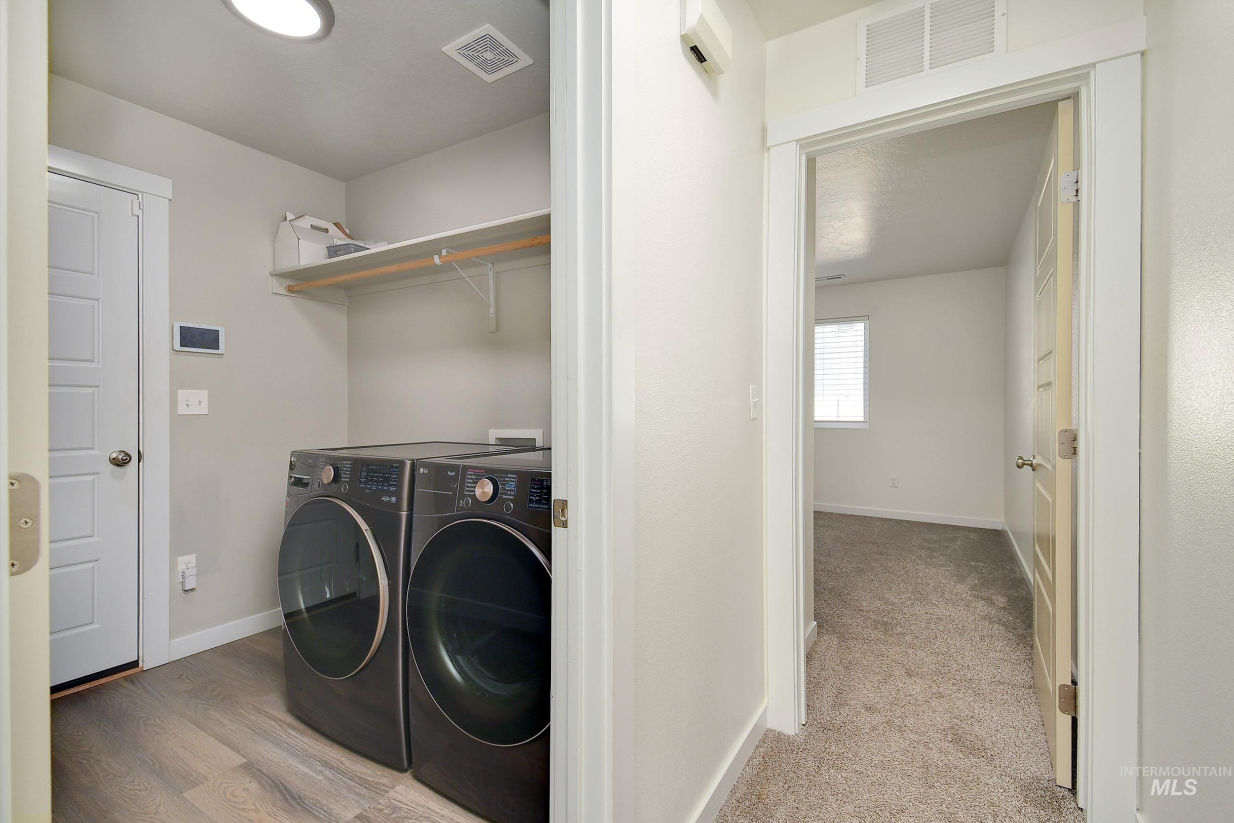 Laundry room with baseboards and washer and dryer
