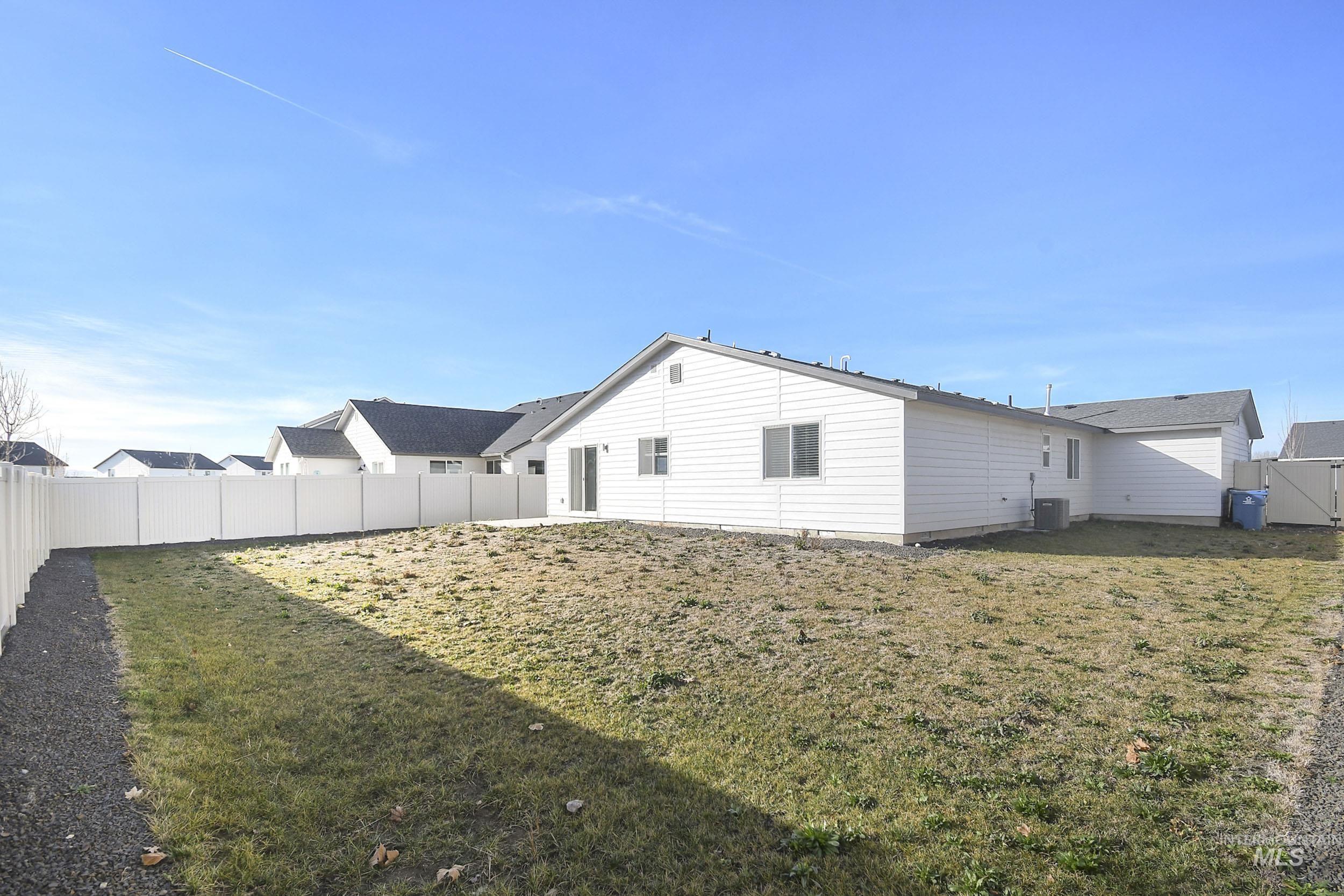 Back of property with a fenced backyard
