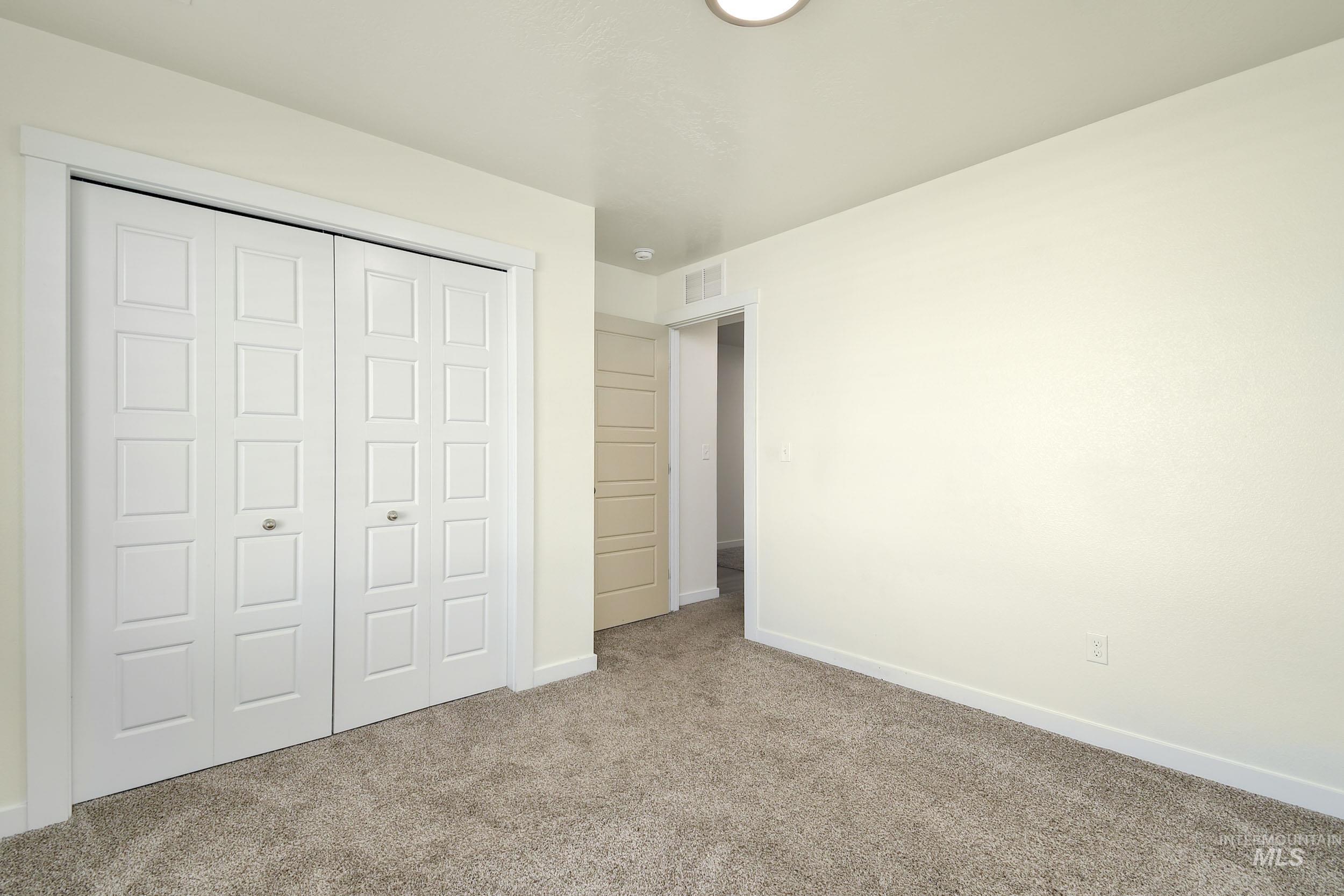 Unfurnished bedroom with a closet and carpet
