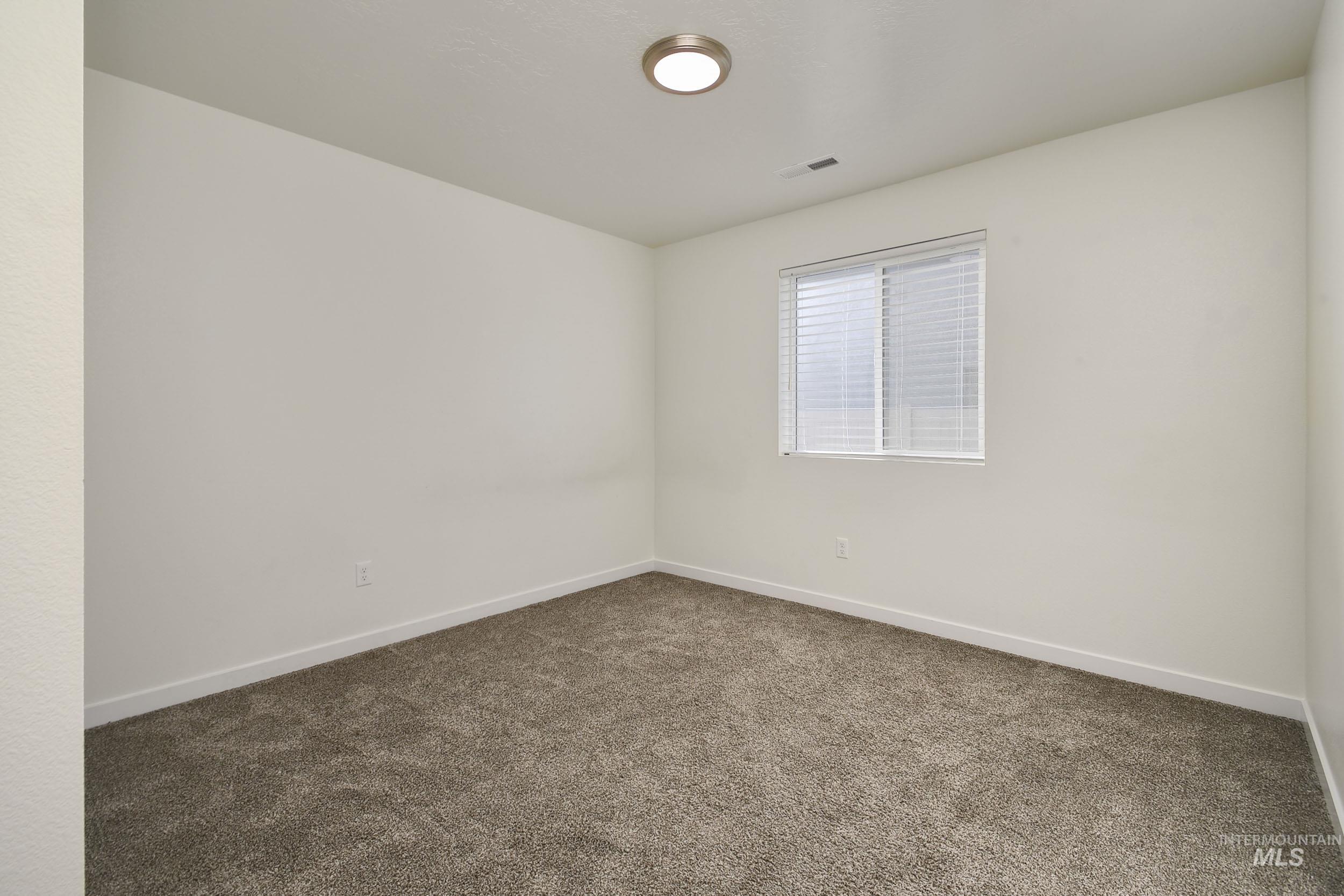 Unfurnished room featuring carpet floors and baseboards
