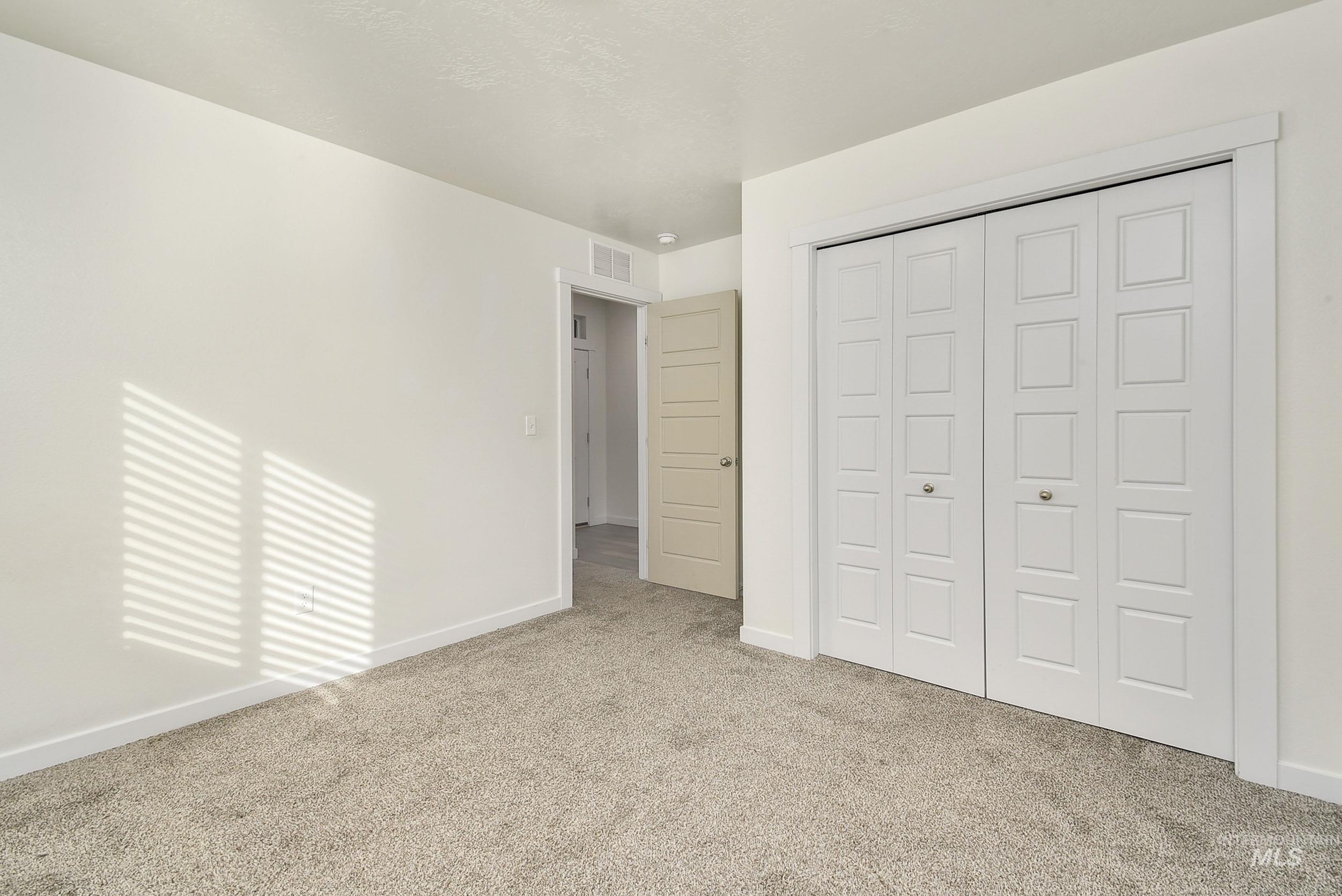 Unfurnished bedroom with carpet floors and a closet
