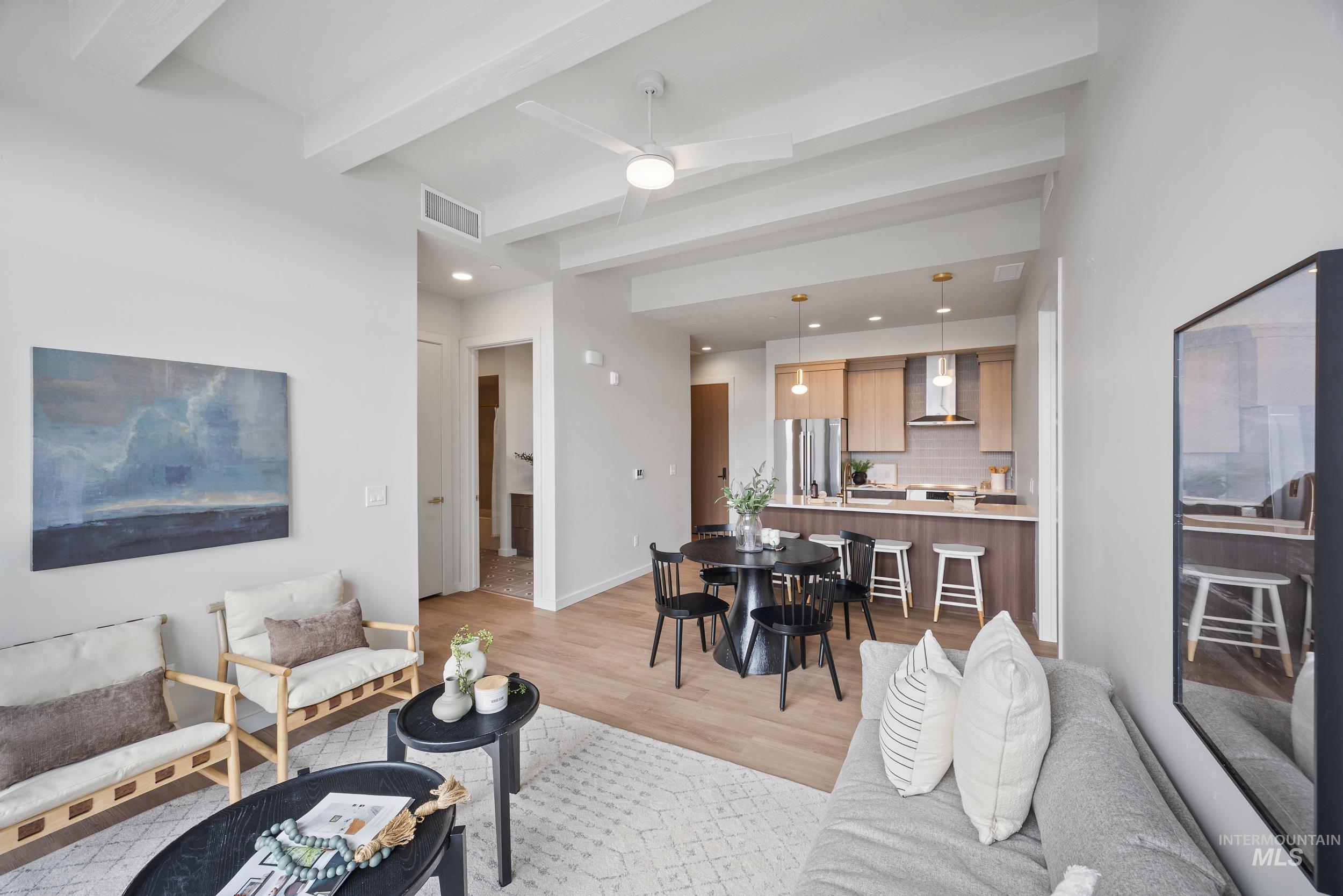 Living room with beamed ceiling, light wood-style flooring, a ceiling fan, and recessed lighting