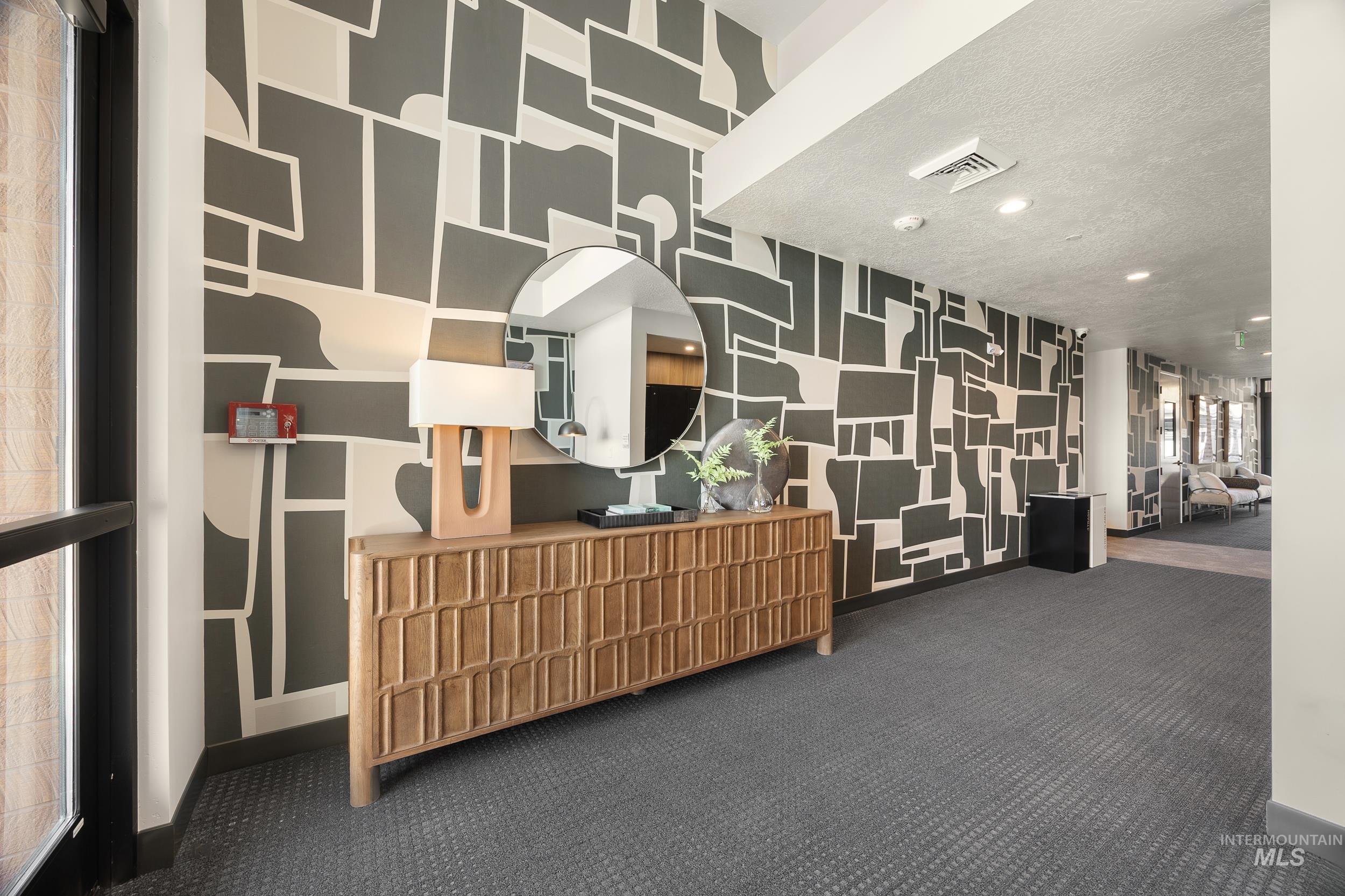 Welcome area featuring wallpapered walls, recessed lighting, and a textured ceiling