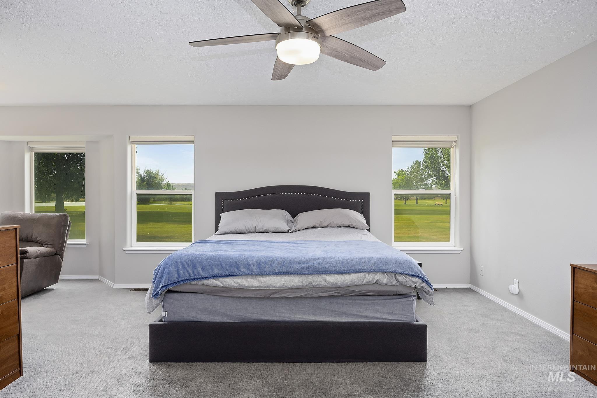 Bedroom featuring light colored carpet and ceiling fan