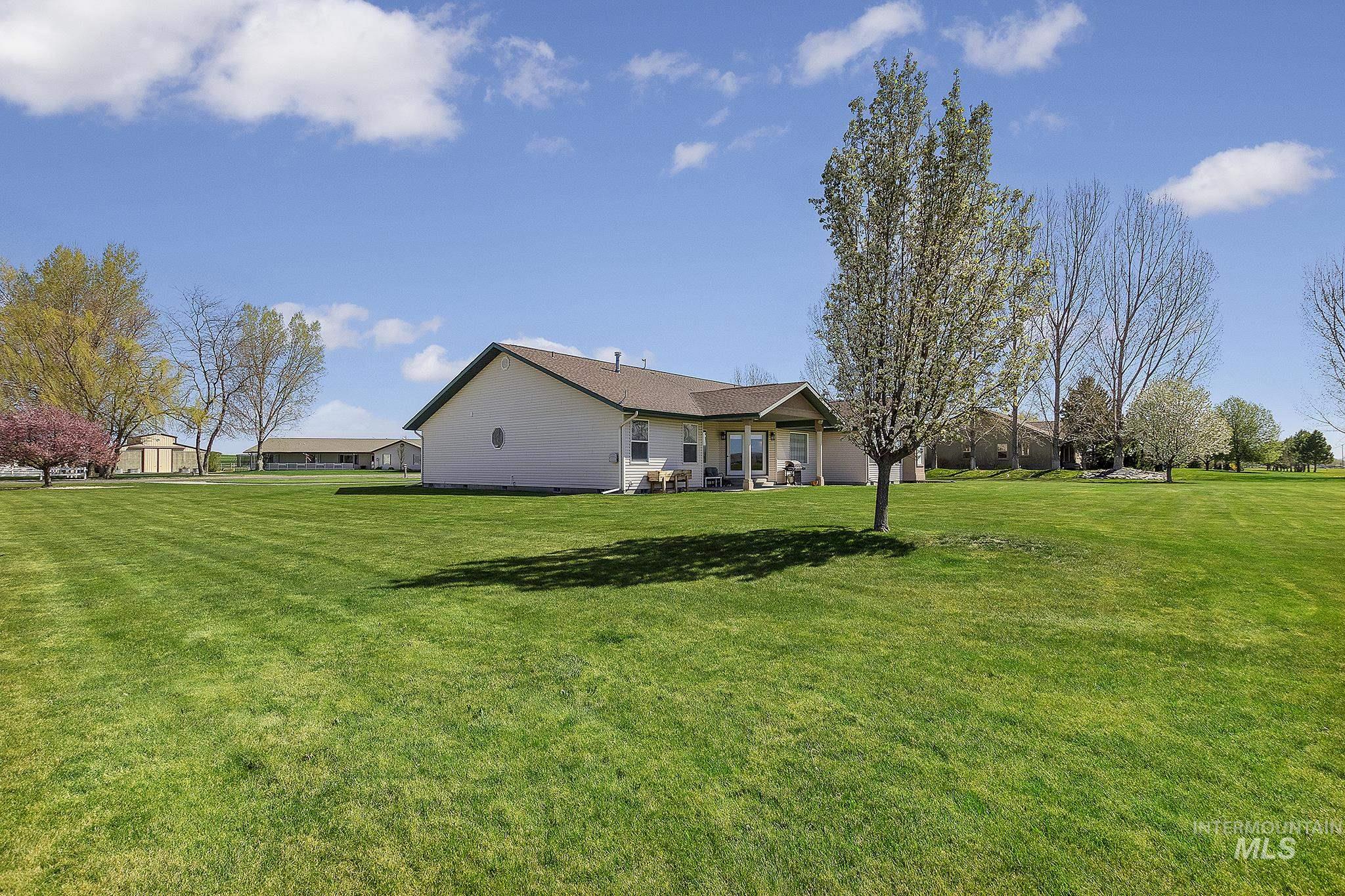 View of green lawn featuring a patio
