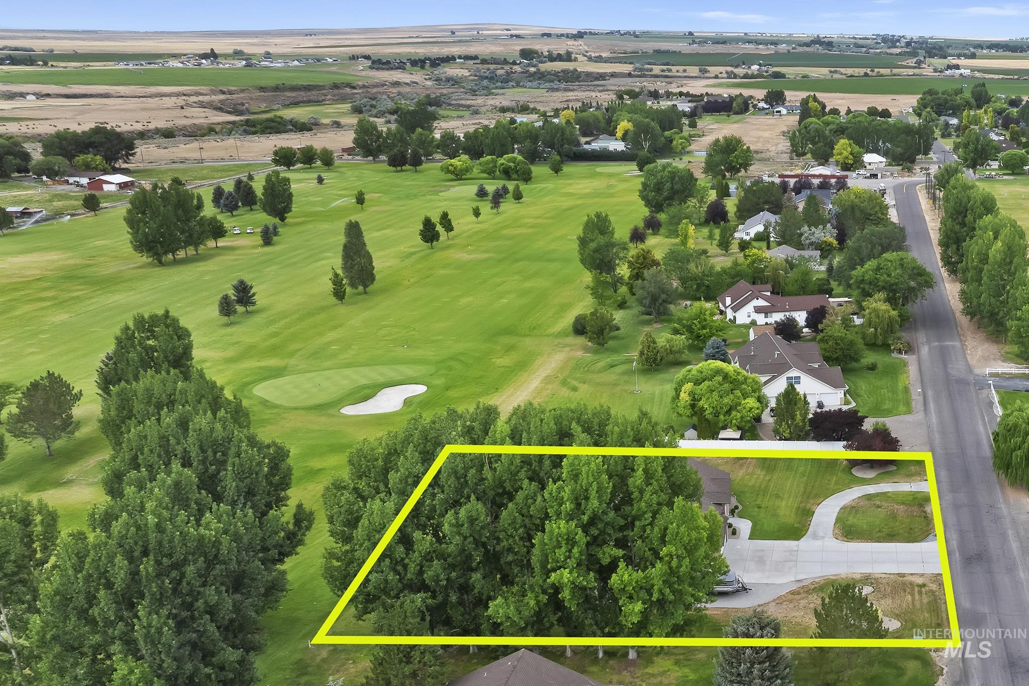 Aerial view of property's location featuring a golf course and property boundaries highlighted