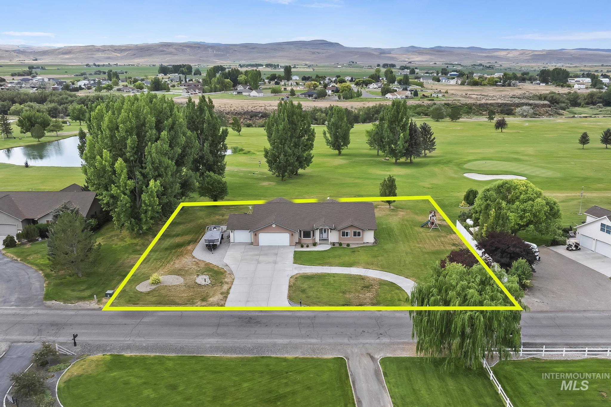 Aerial overview of property's location featuring a water and mountain view, property boundaries highlighted, and a golf course