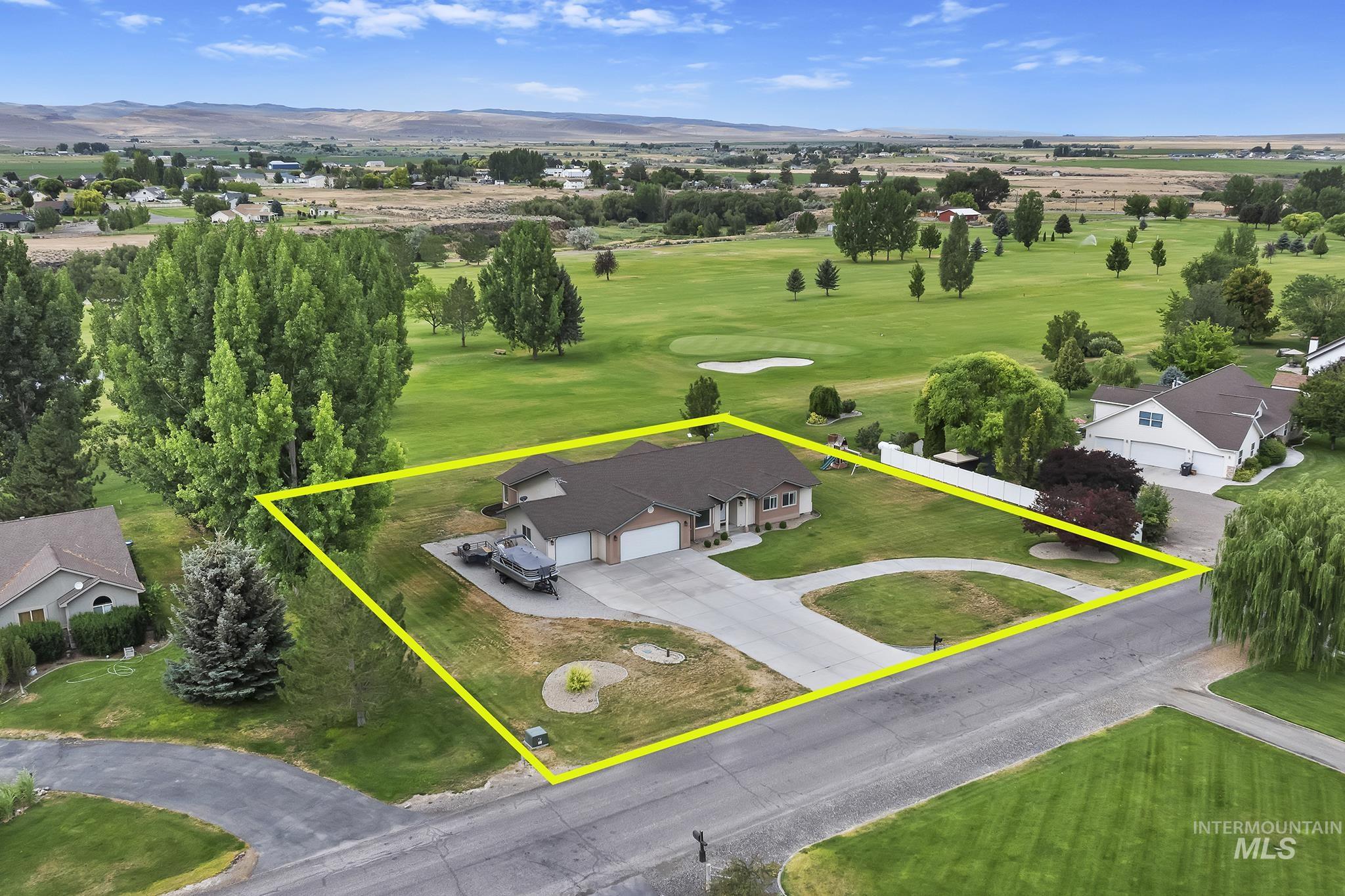 Aerial view of property's location with property boundaries highlighted and a mountain backdrop