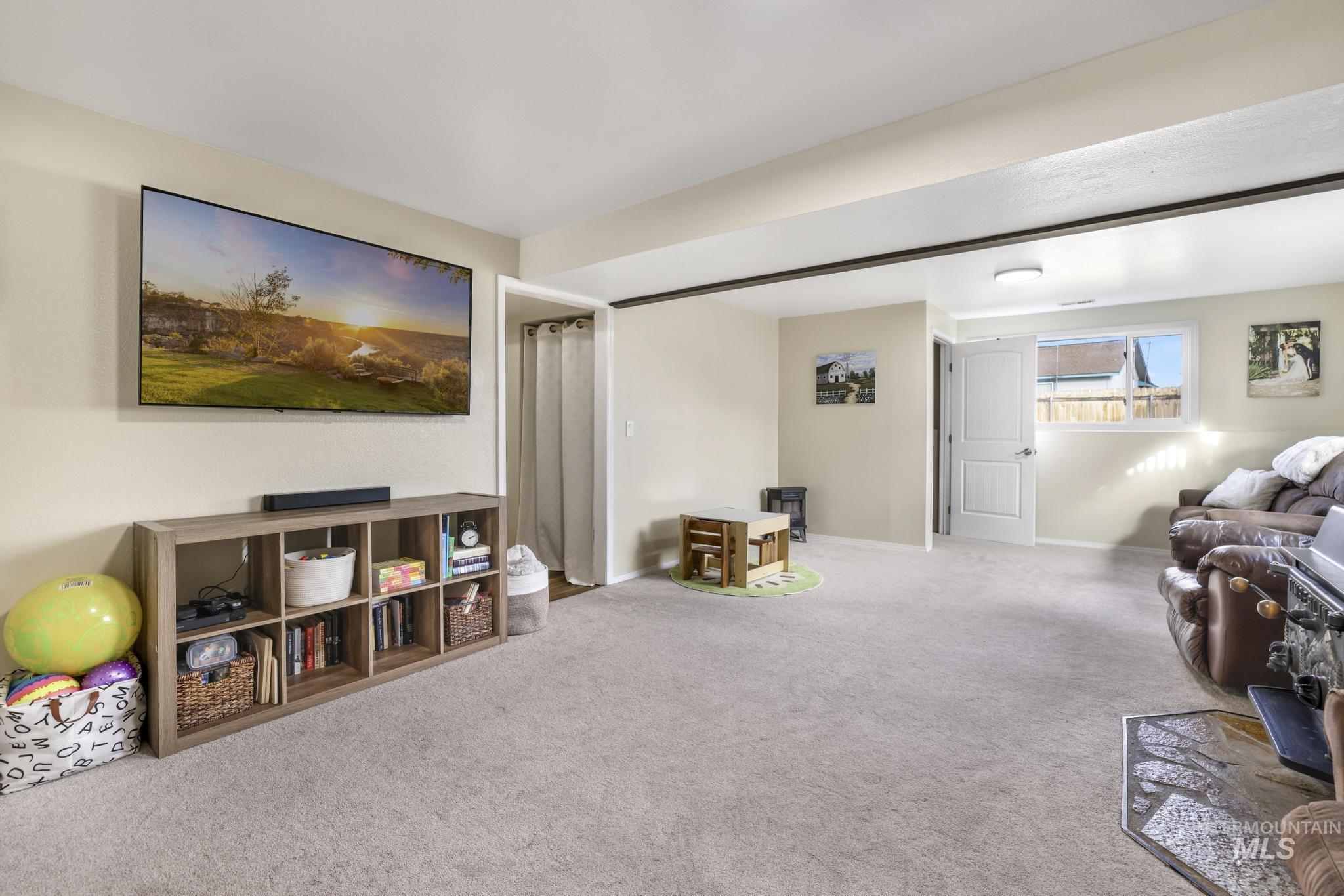 Carpeted living area featuring baseboards