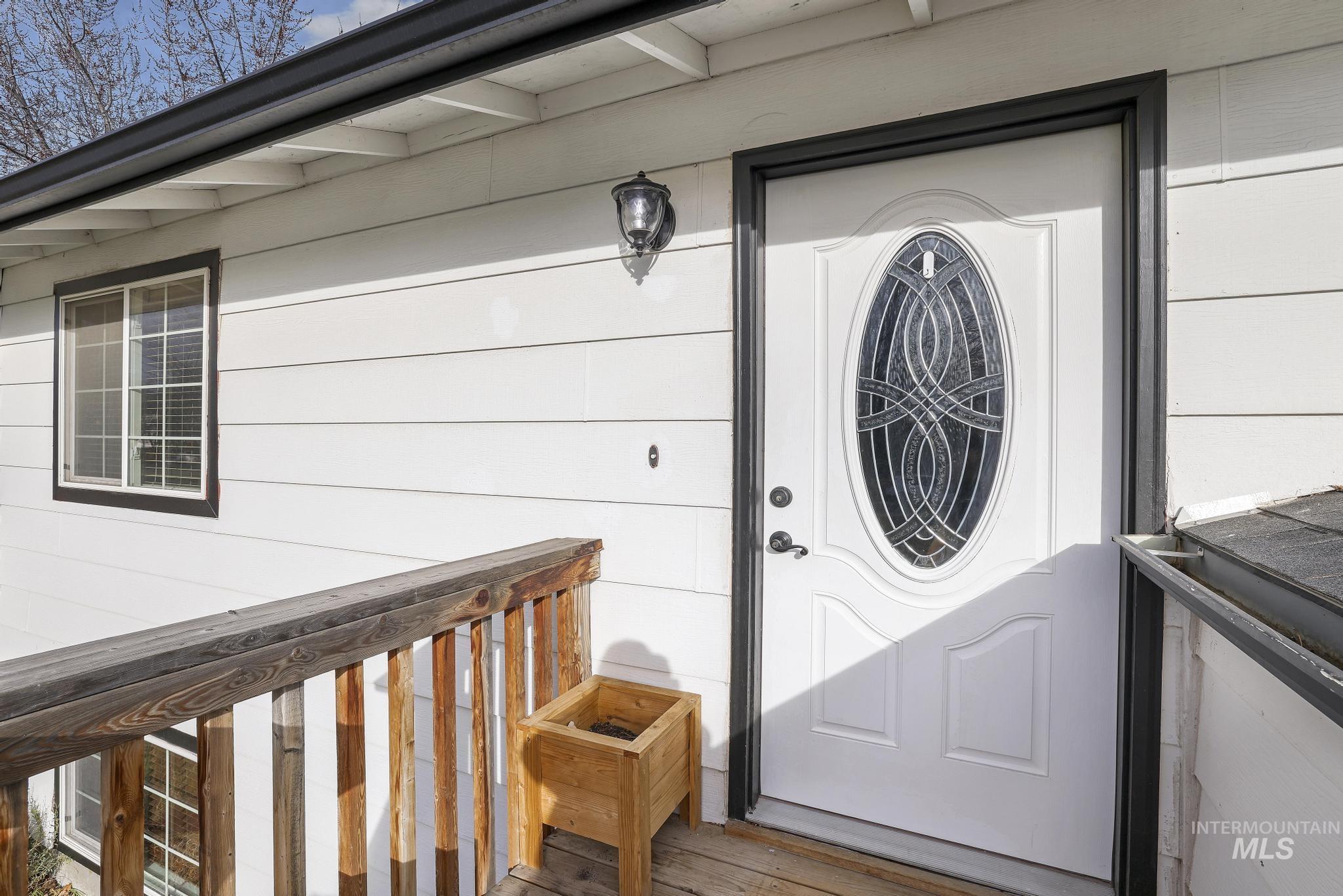 View of exterior entry with a deck
