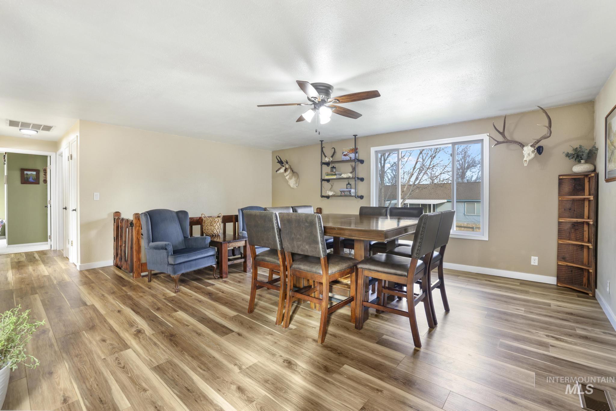Dining area featuring light wood-style floors and a ceiling fan