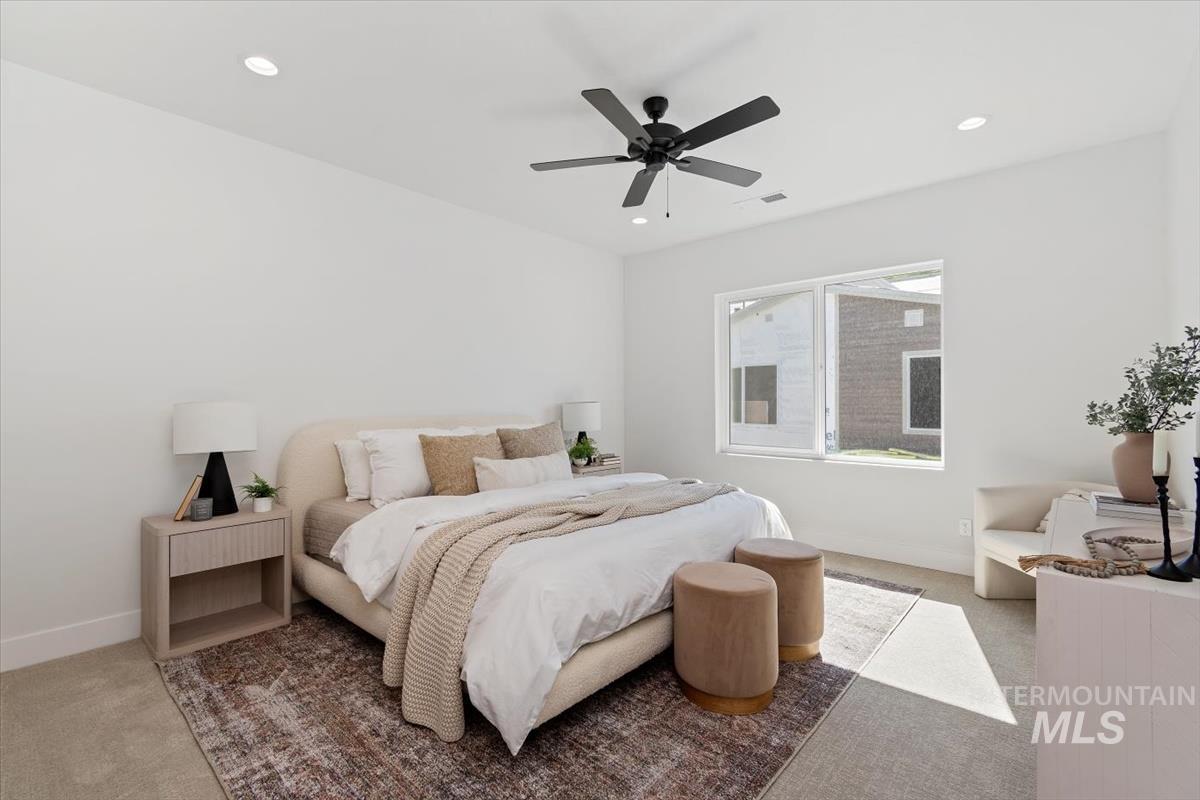 Bedroom with carpet, ceiling fan, and recessed lighting