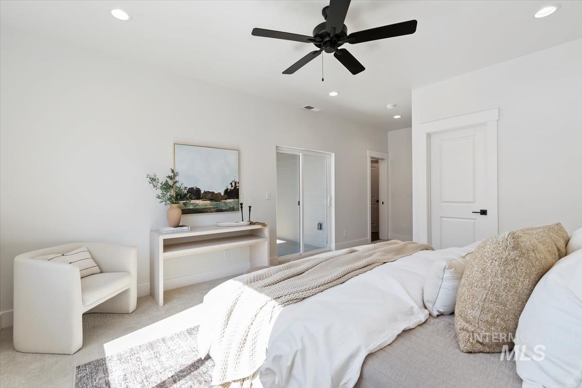 Carpeted bedroom featuring a ceiling fan and recessed lighting