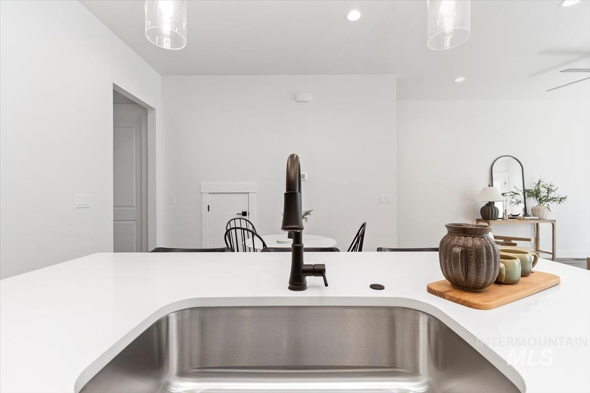 Kitchen featuring recessed lighting, a breakfast bar, and hanging light fixtures