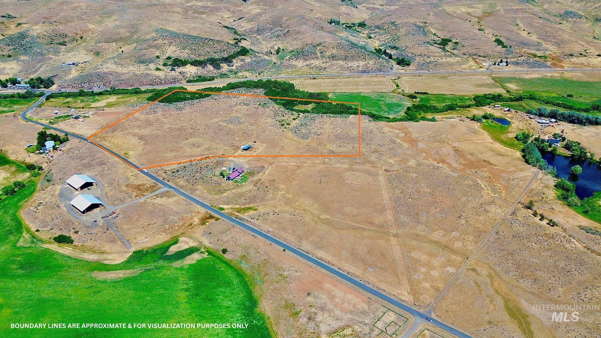 Aerial view of sparsely populated area featuring property parcel outlined