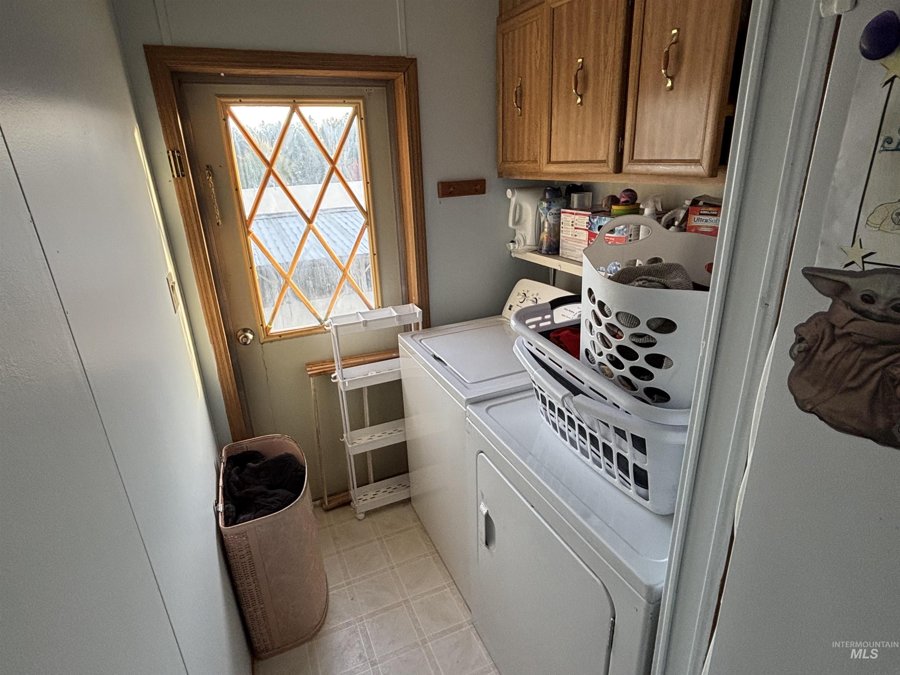 Laundry area with cabinet space and independent washer and dryer