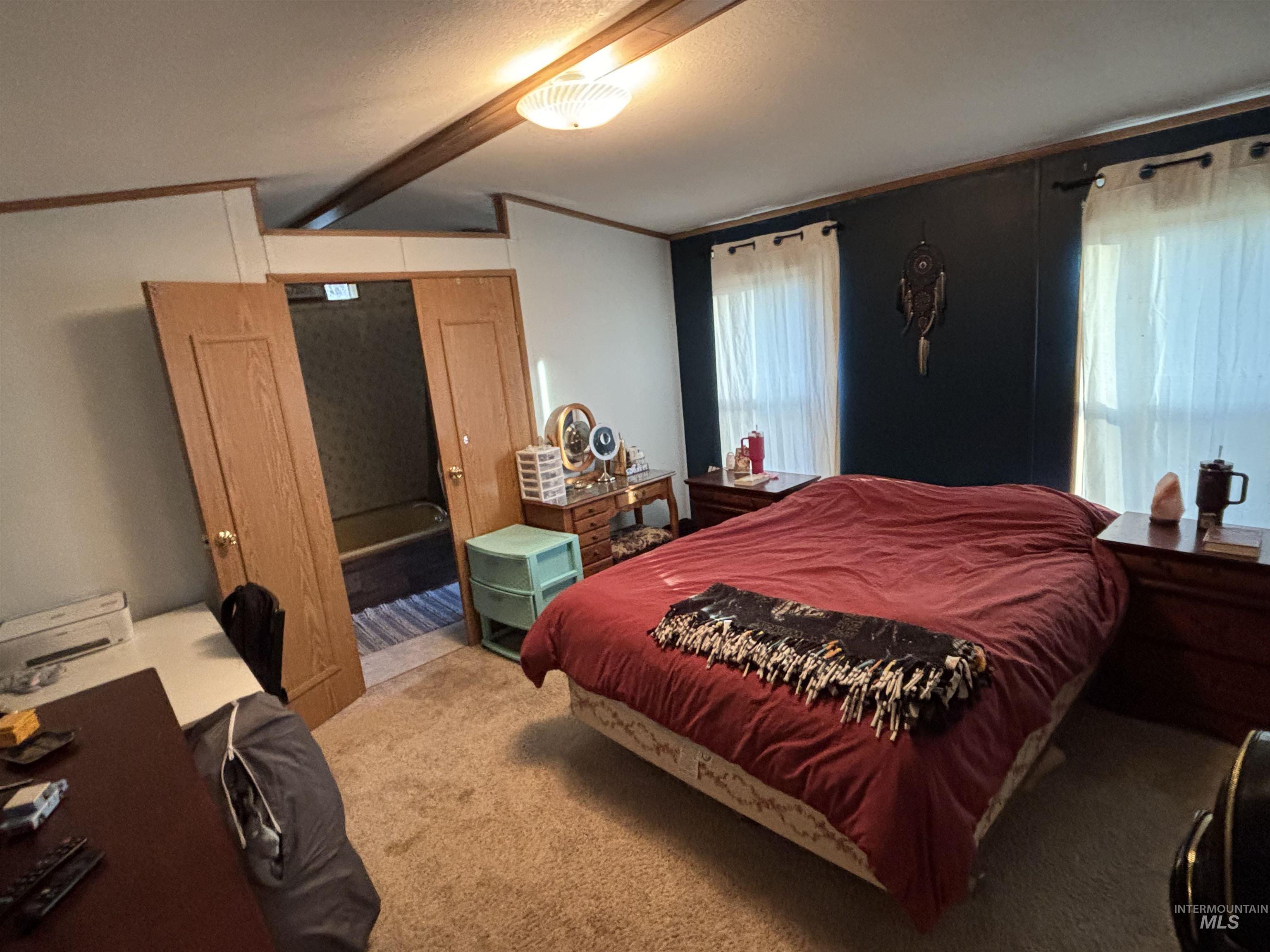 Carpeted bedroom featuring ornamental molding