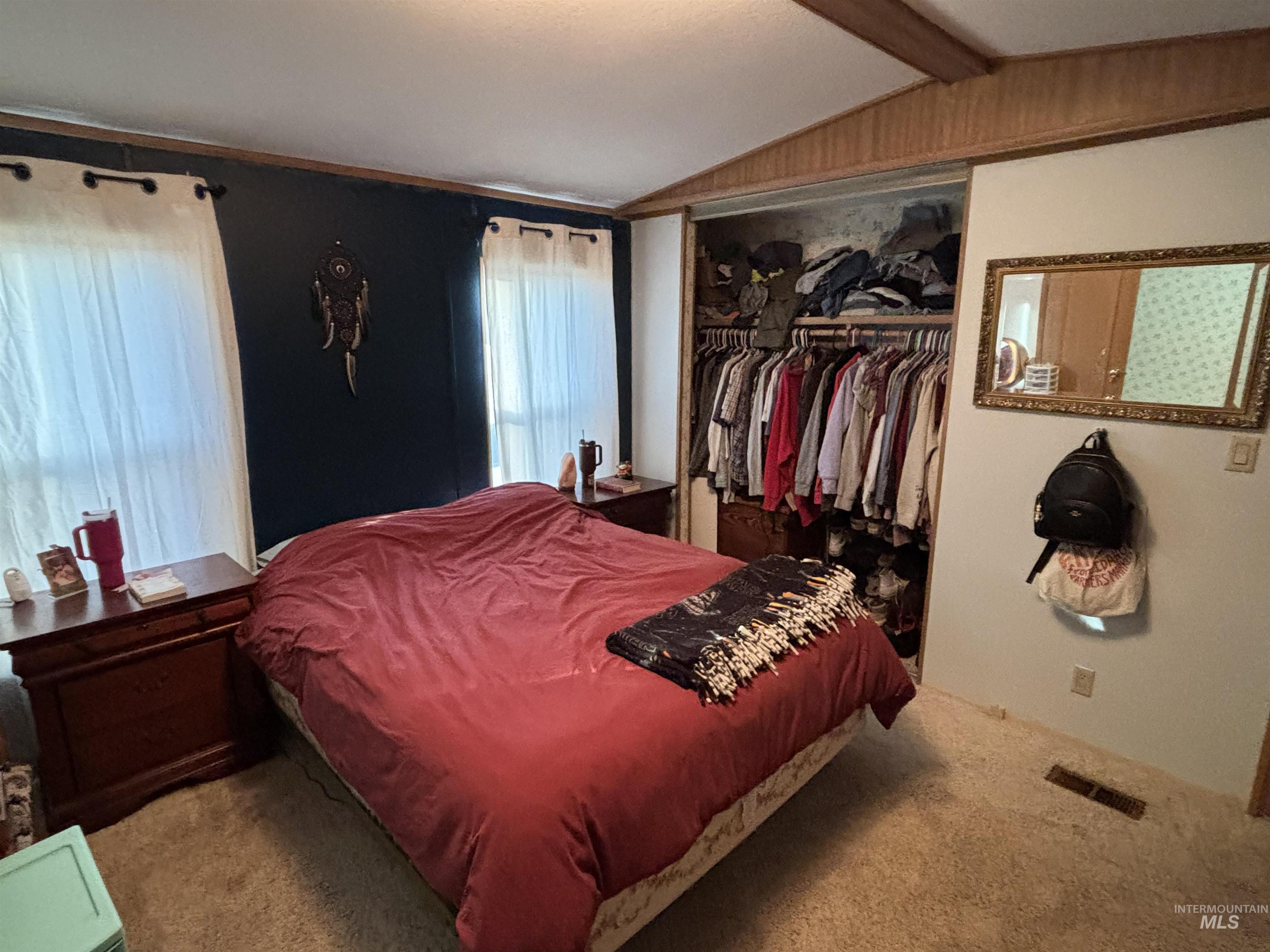 Carpeted bedroom with a closet