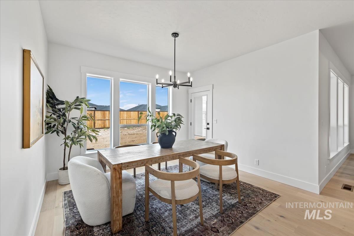 Dining space featuring light wood-style floors and a chandelier