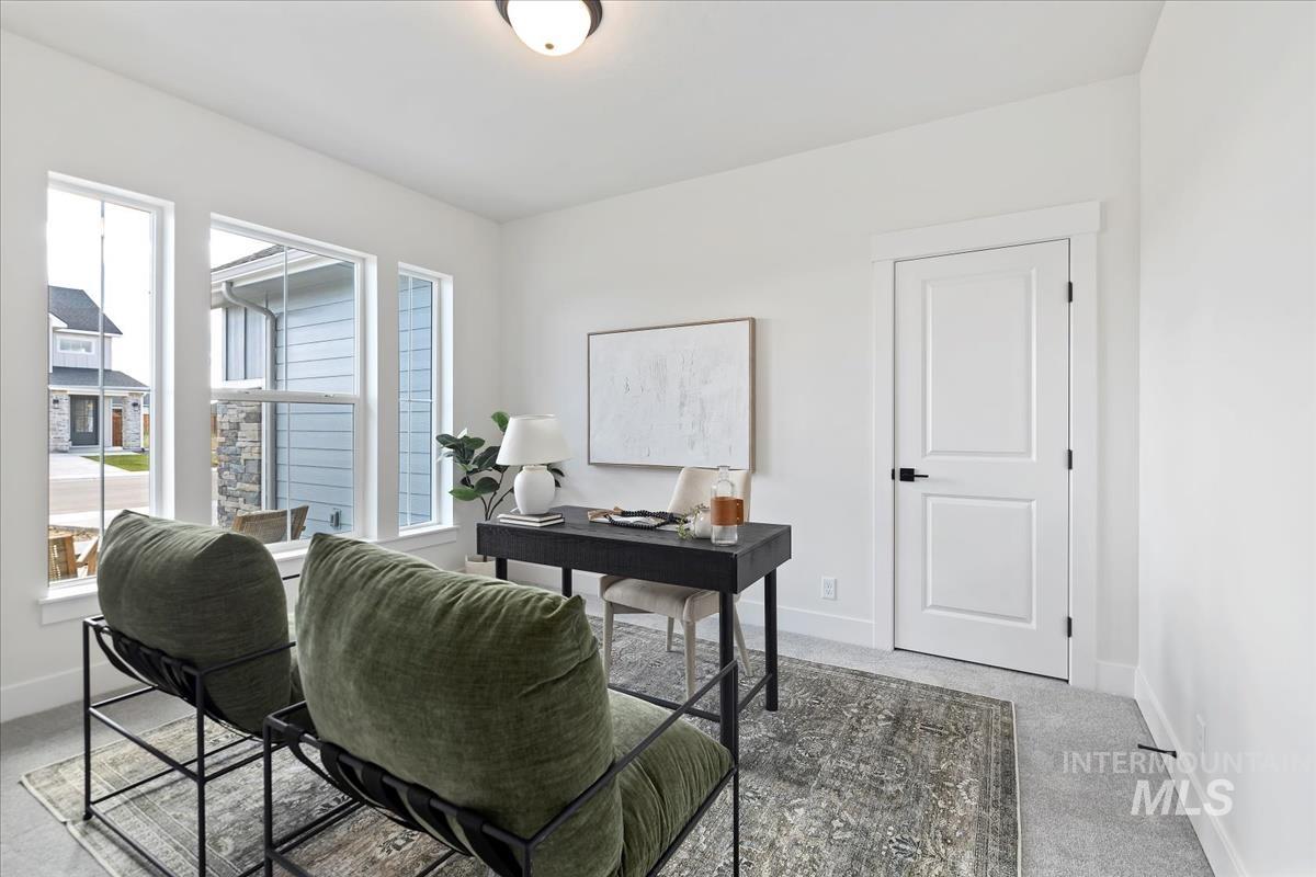 Office space featuring baseboards and light carpet