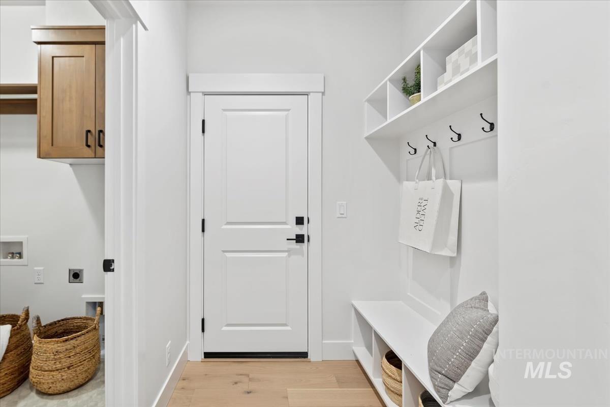 Mudroom featuring light wood-type flooring and baseboards