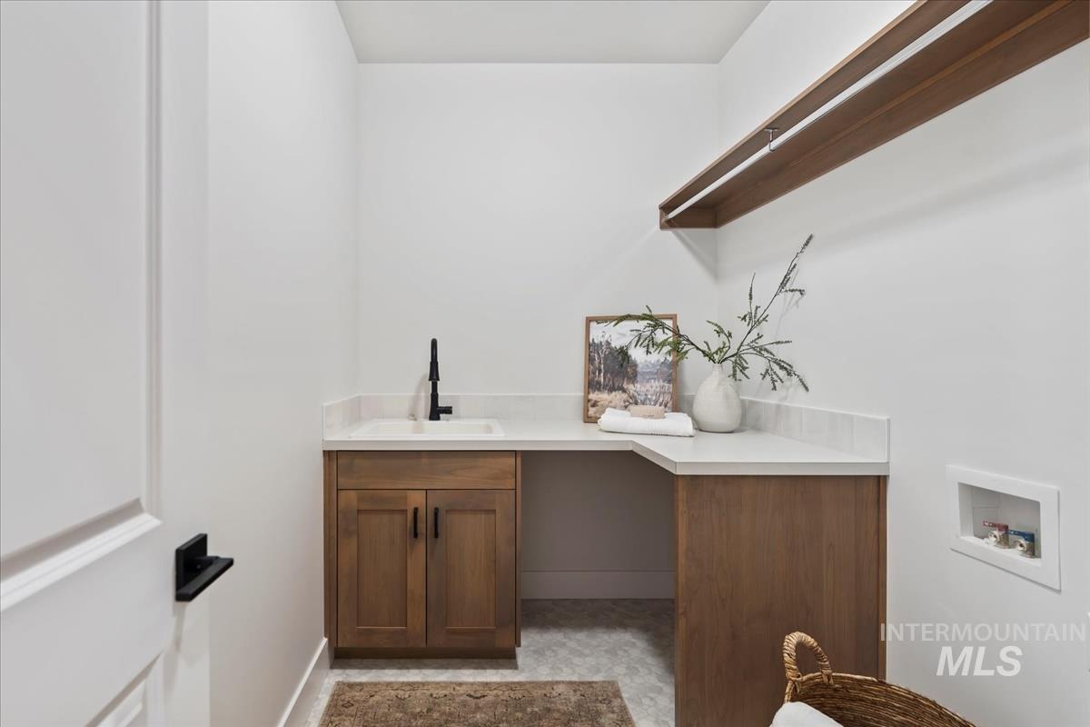 Laundry room featuring washer hookup and cabinet space