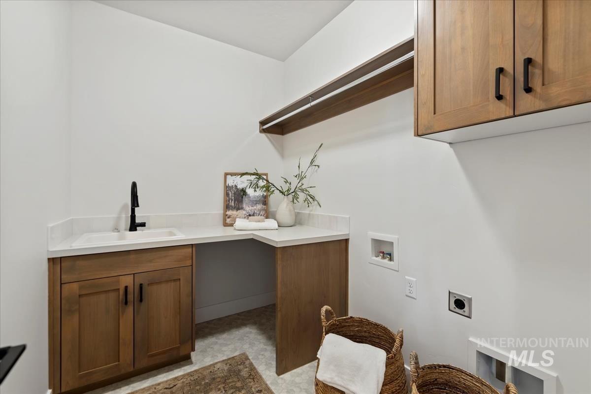 Laundry room featuring hookup for a washing machine, cabinet space, and electric dryer hookup