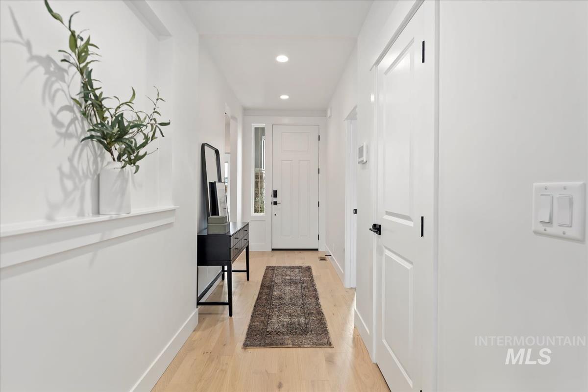Entryway featuring wood finished floors and recessed lighting