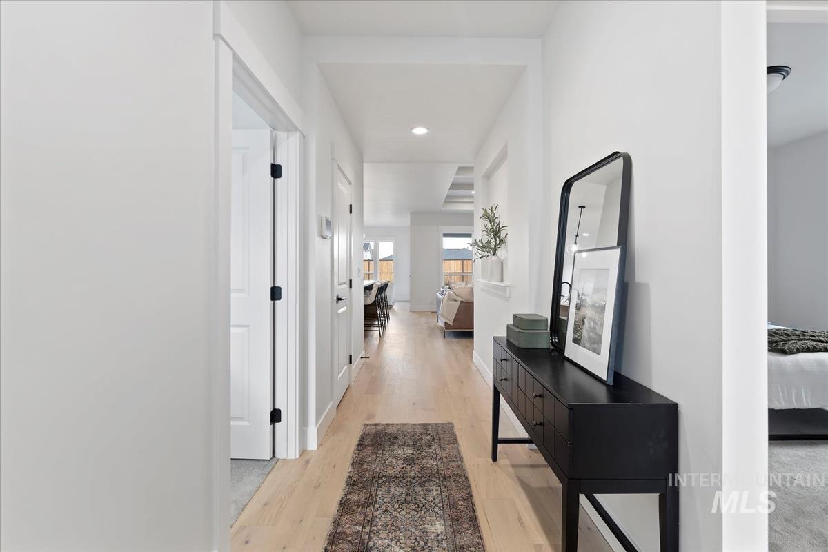 Hall featuring light wood-style floors and recessed lighting