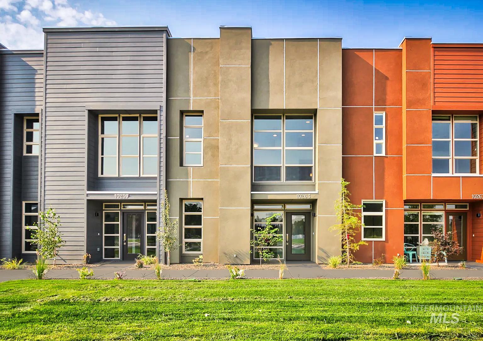 Front of property with stucco siding and a lawn