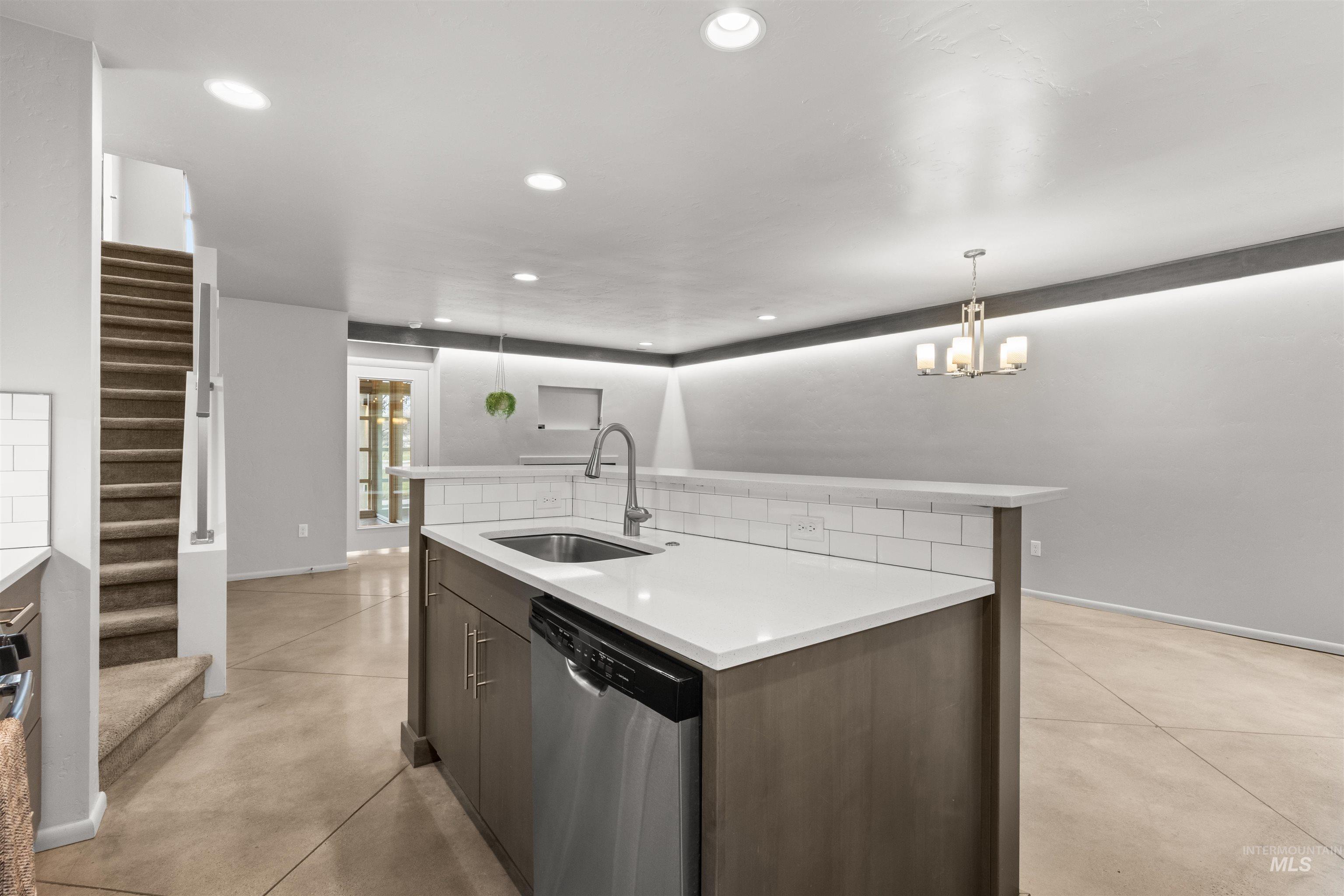 Kitchen featuring dishwasher, a kitchen island with sink,  concrete floors, and recessed lighting