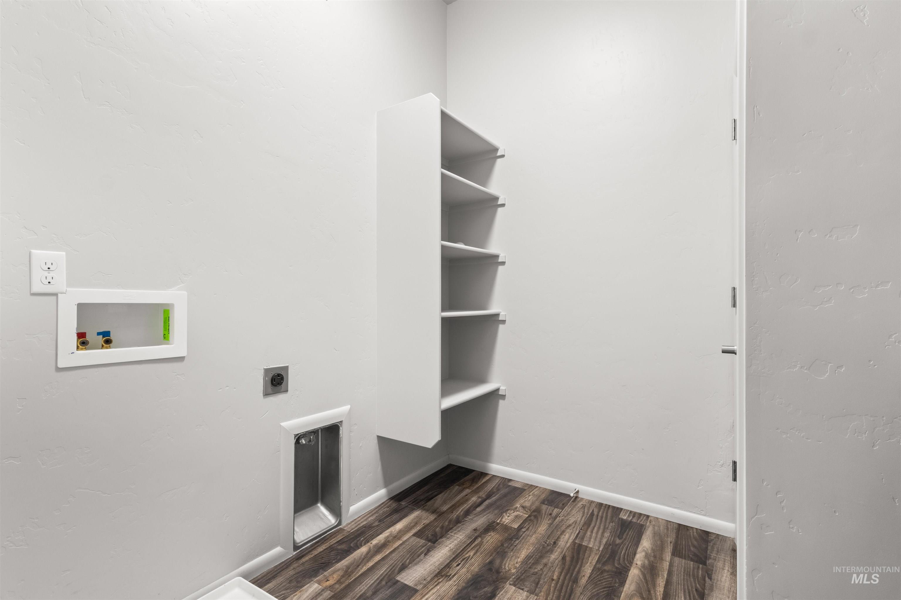 Laundry area featuring wood-look vinyl floors, a textured wall, hookup for an electric dryer, and hookup for a washing machine