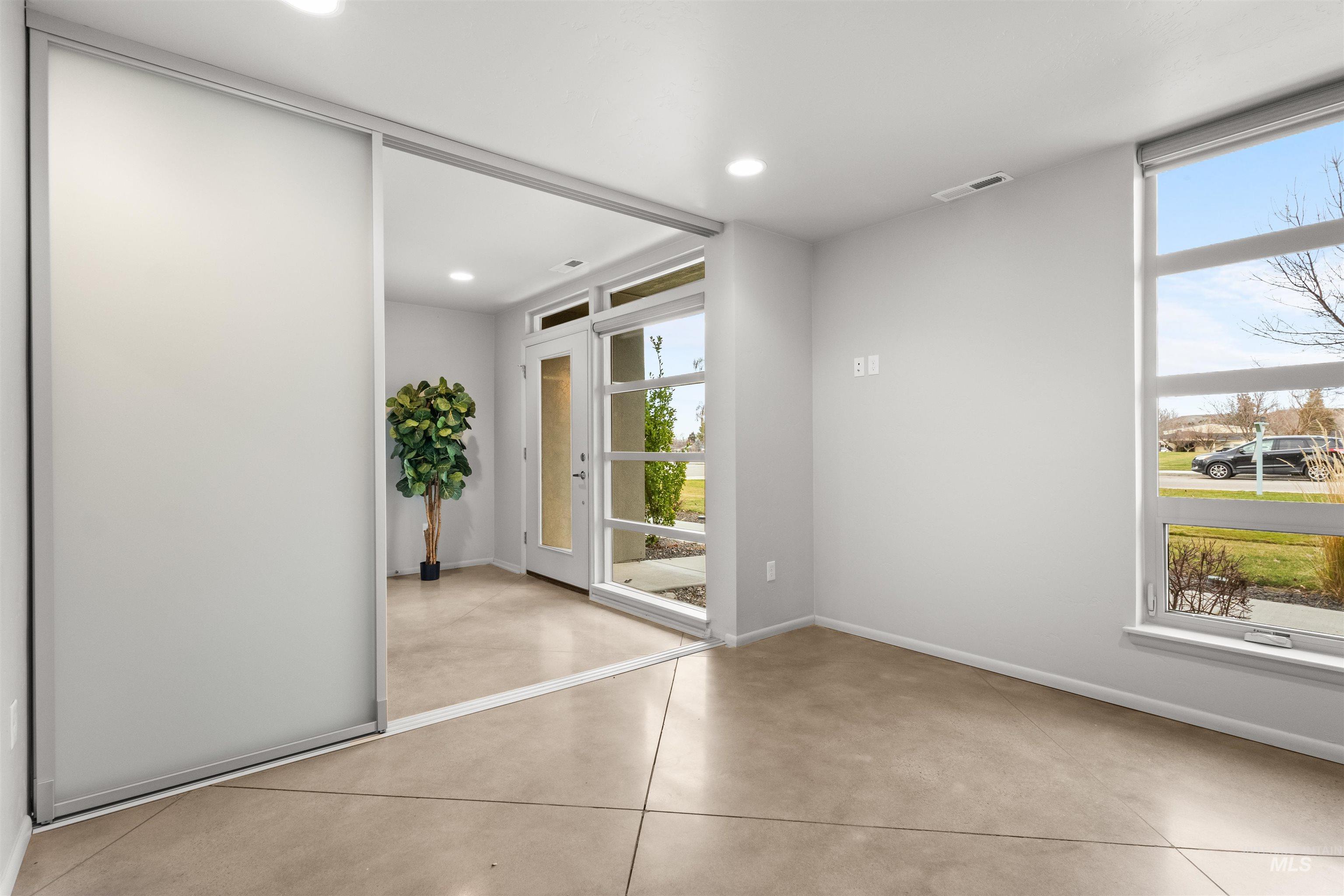 Bedroom/flex room with concrete floors and recessed lighting