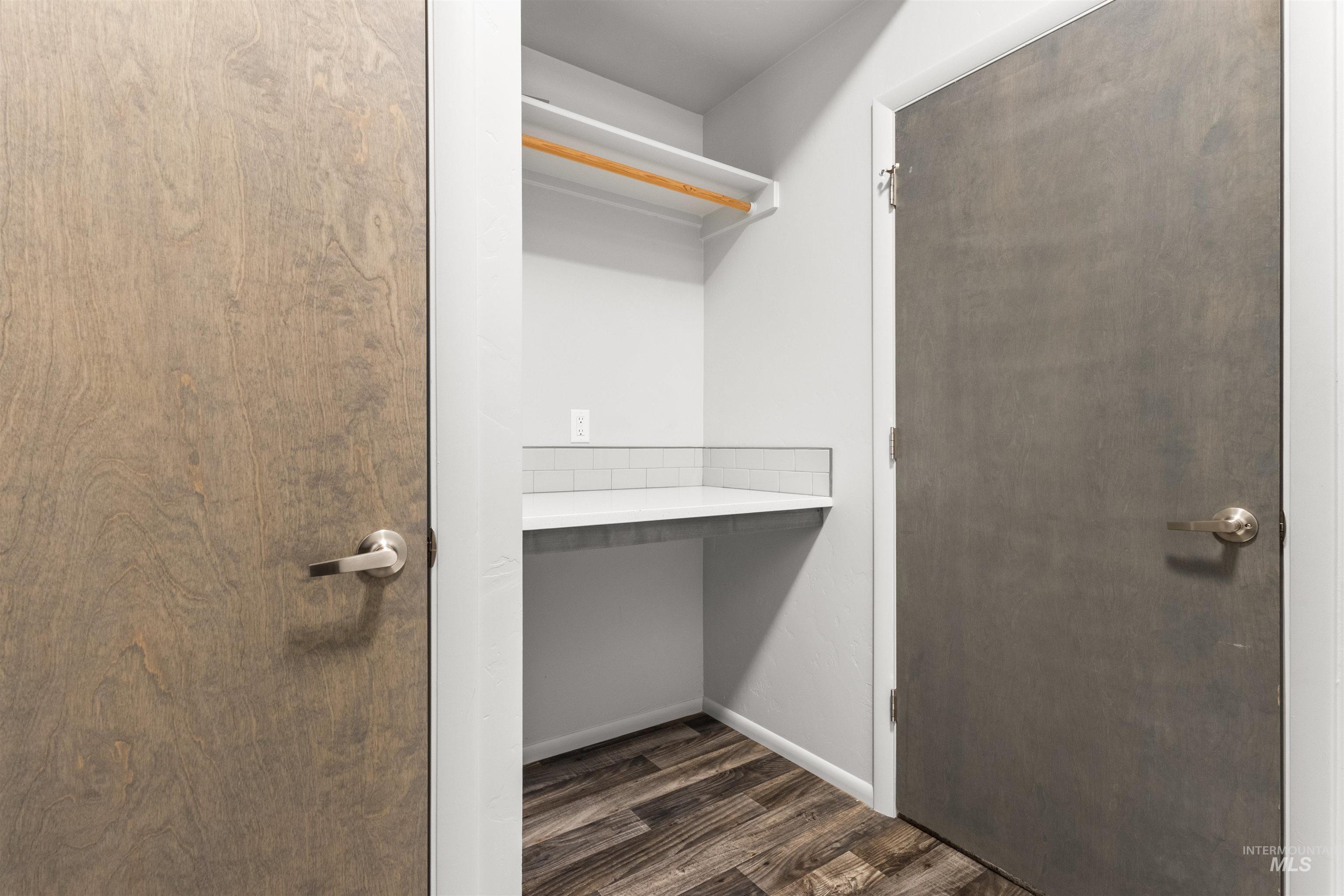 Laundry room featuring folding and hanging area, mechanical closet