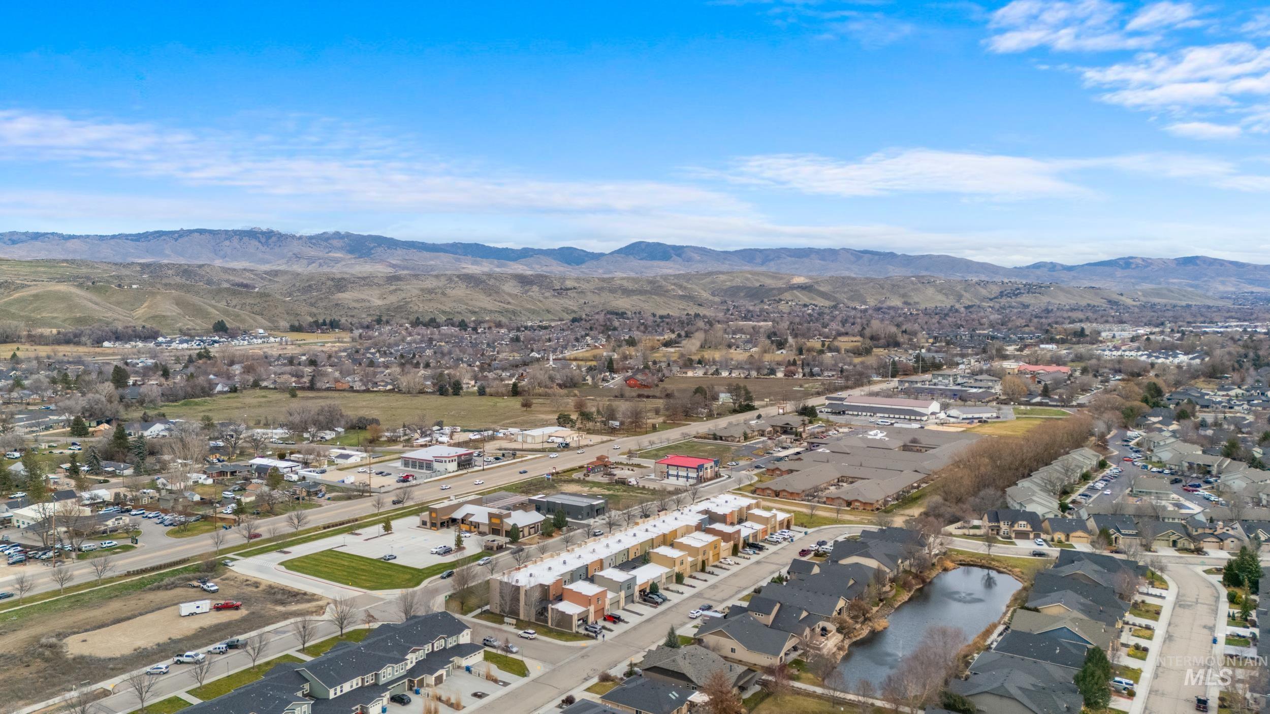 View of property location featuring a mountainous background and nearby suburban area